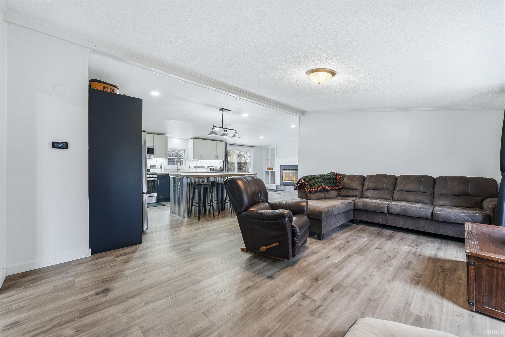 Living area featuring light wood-type flooring and recessed lighting