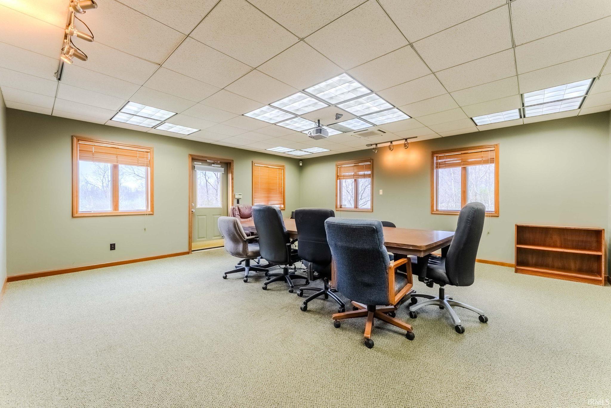 Home office featuring light colored carpet and a drop ceiling