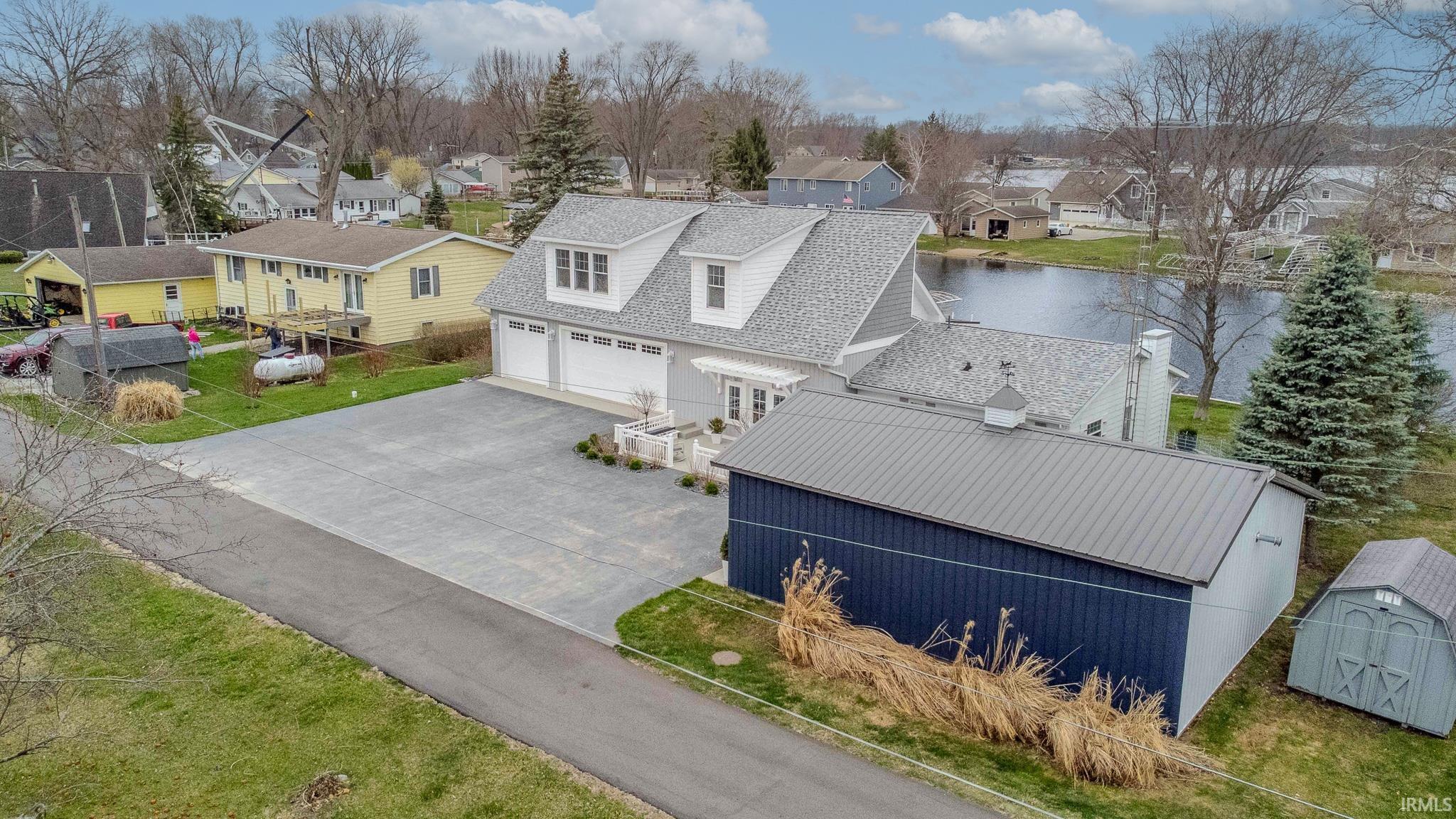 Aerial perspective of suburban area featuring a large body of water