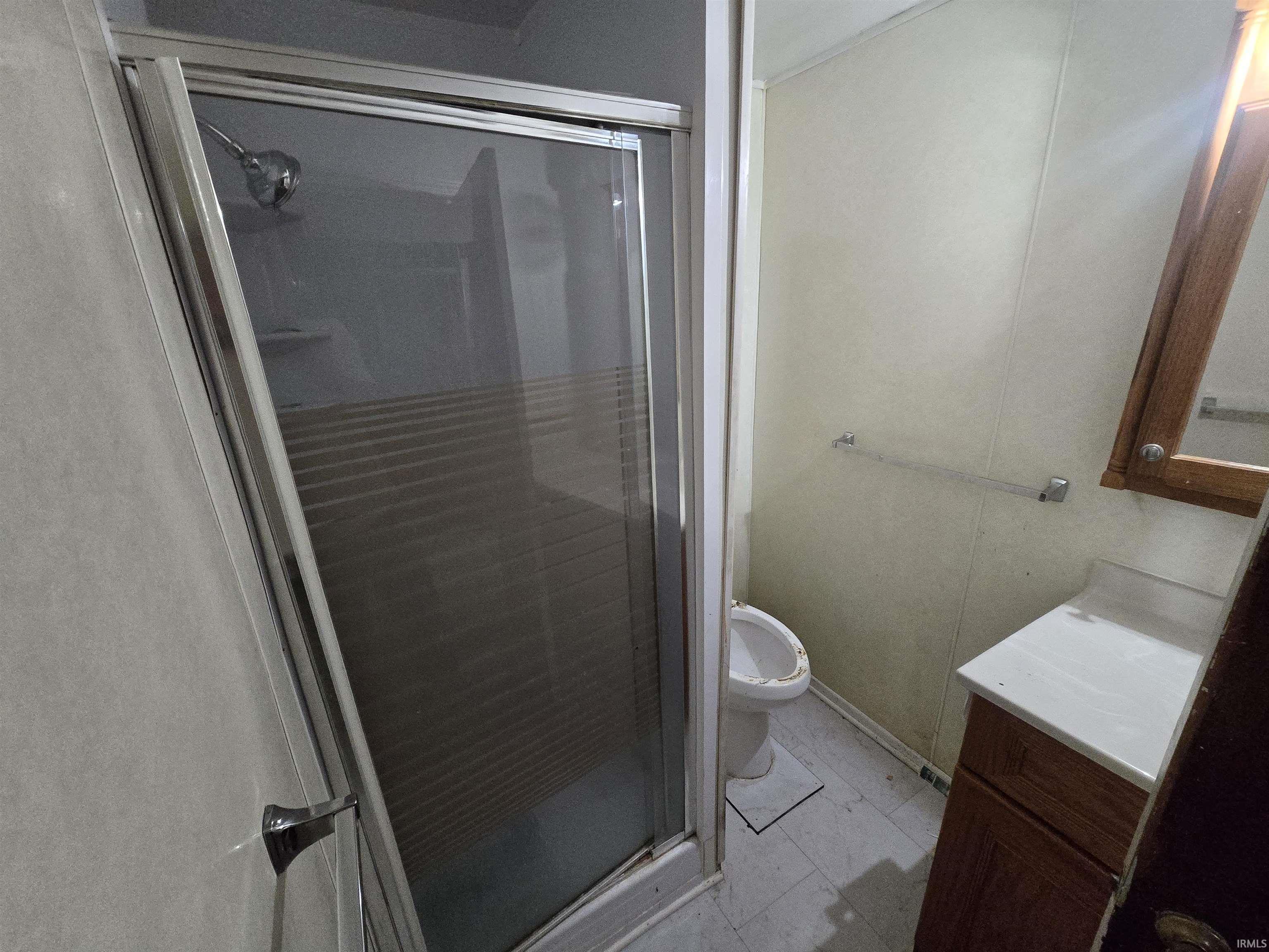 Full bathroom with vanity and a shower stall