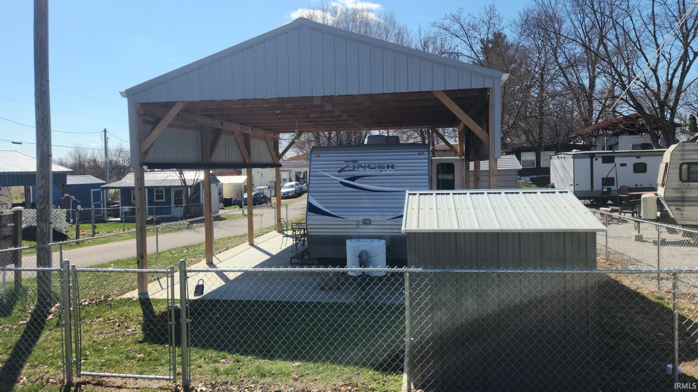 Dock area with a residential view, a gate, and a patio