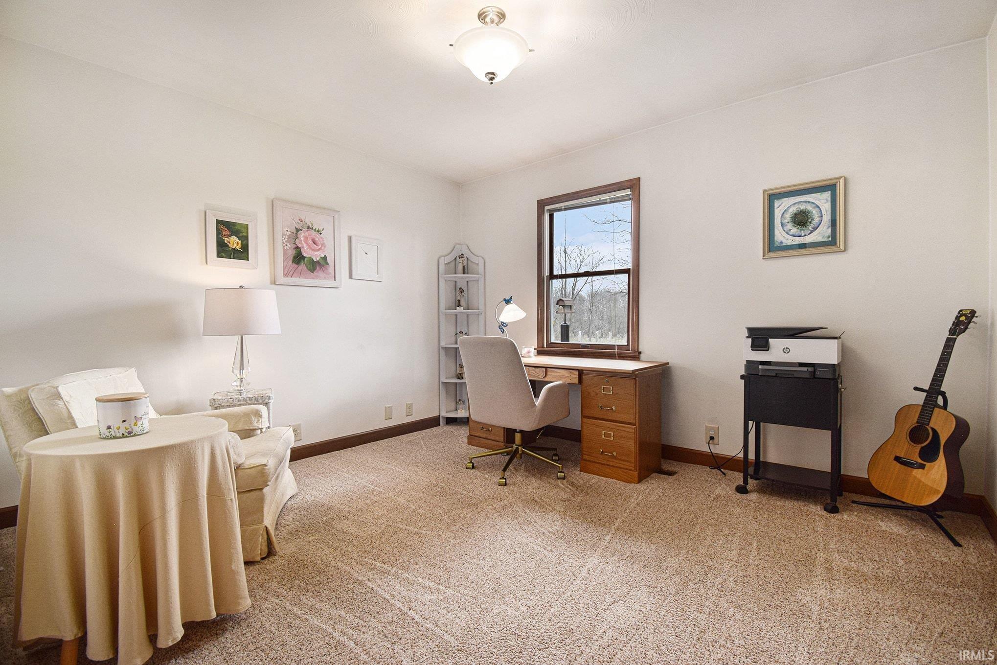 Home office with light carpet and baseboards
