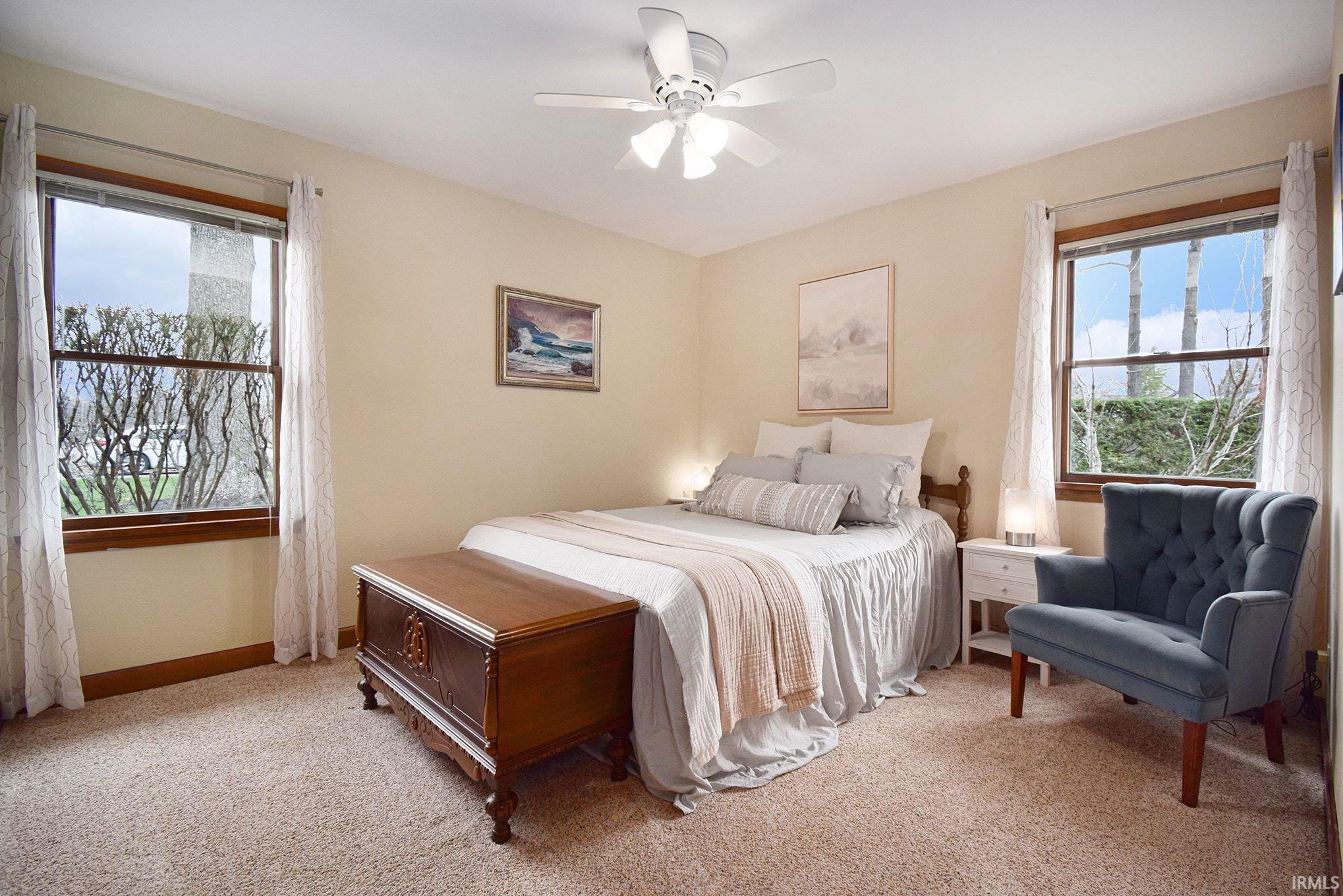 Bedroom featuring light colored carpet and a ceiling fan