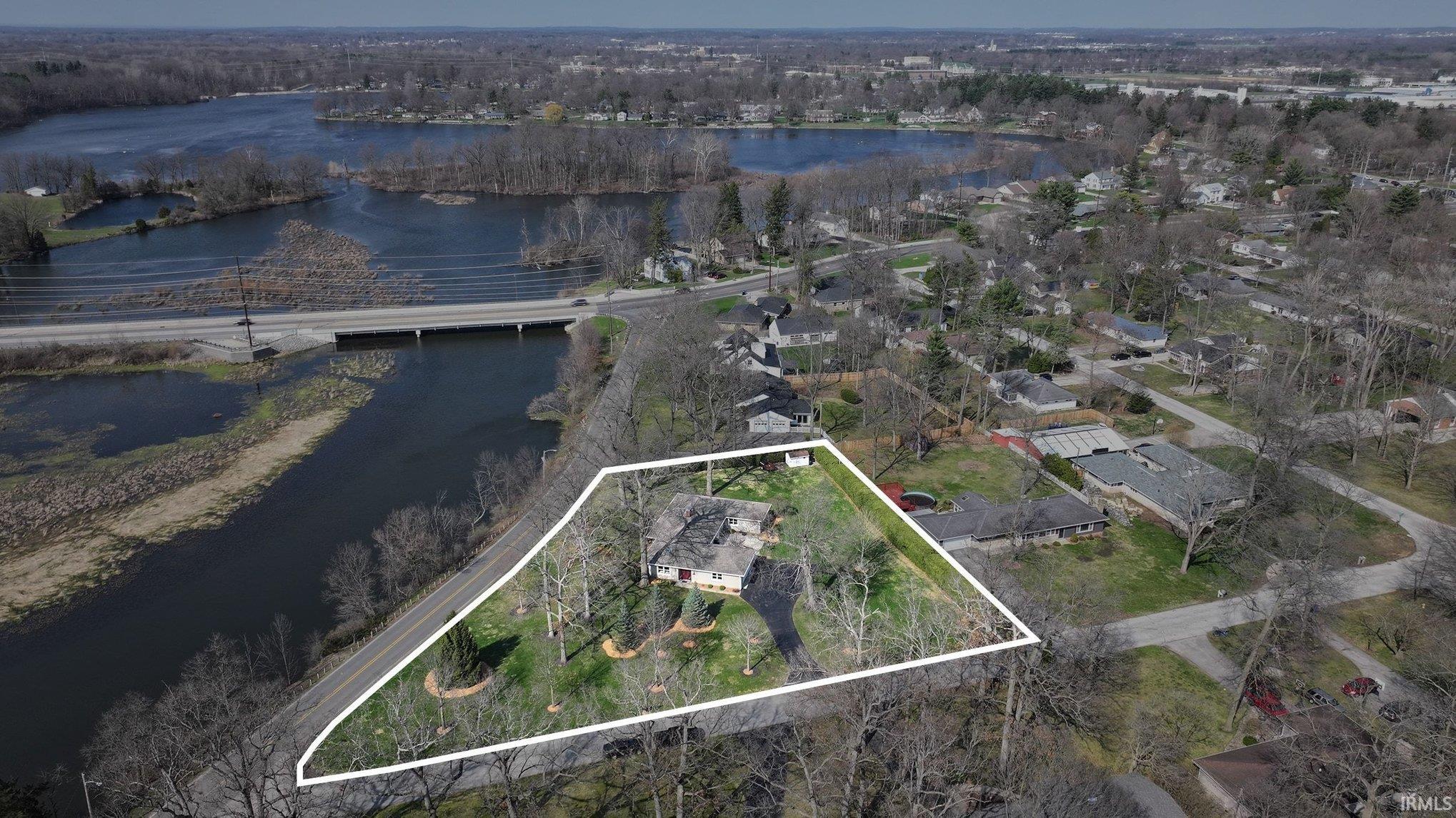 Aerial view of property's location with property parcel outlined and a nearby body of water