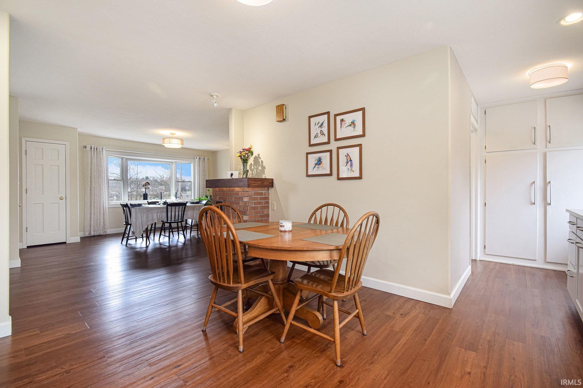 Dining room with dark wood-style flooring