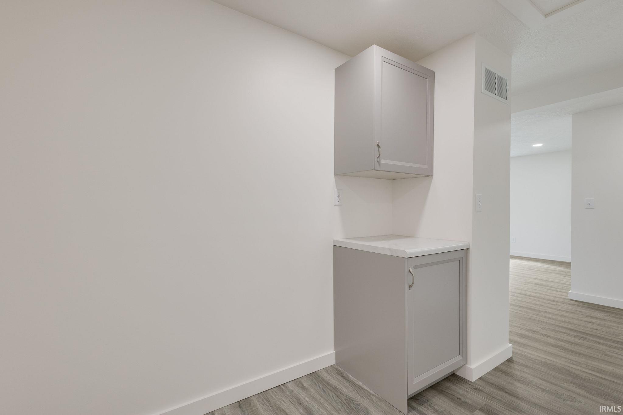 Detailed view of recessed lighting and wood finished floors