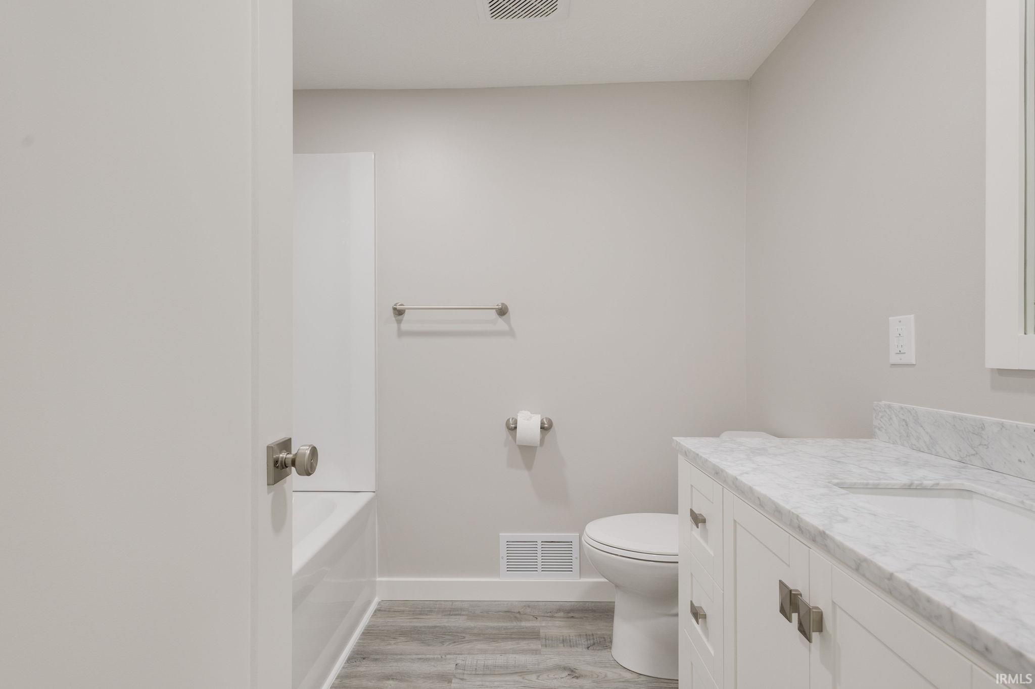 Bathroom with vanity and light wood finished floors