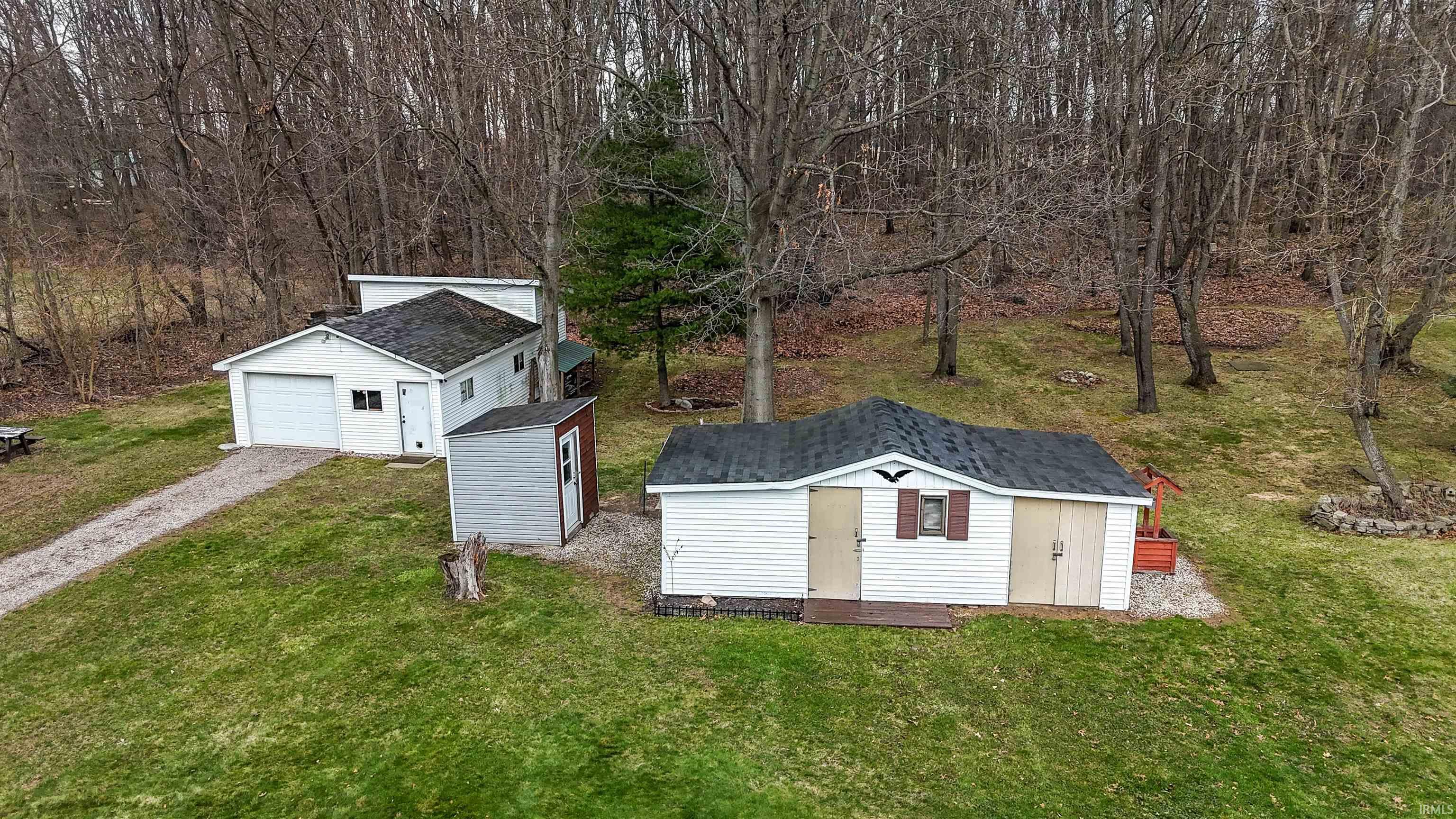 View of shed with driveway and a garage