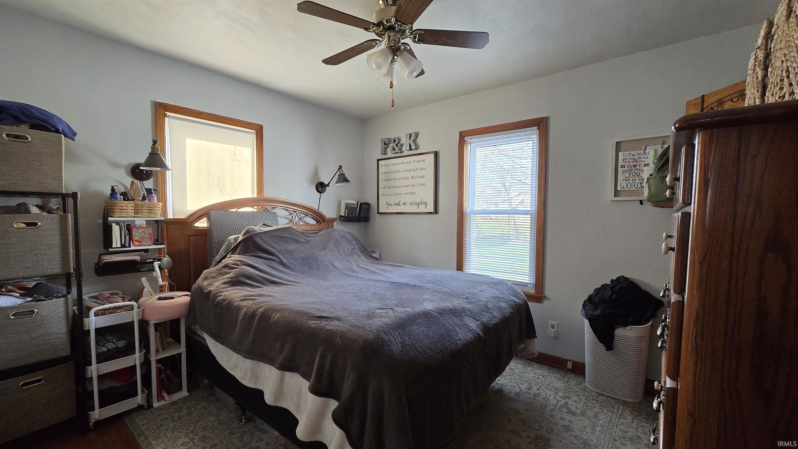 Bedroom with ceiling fan and baseboards