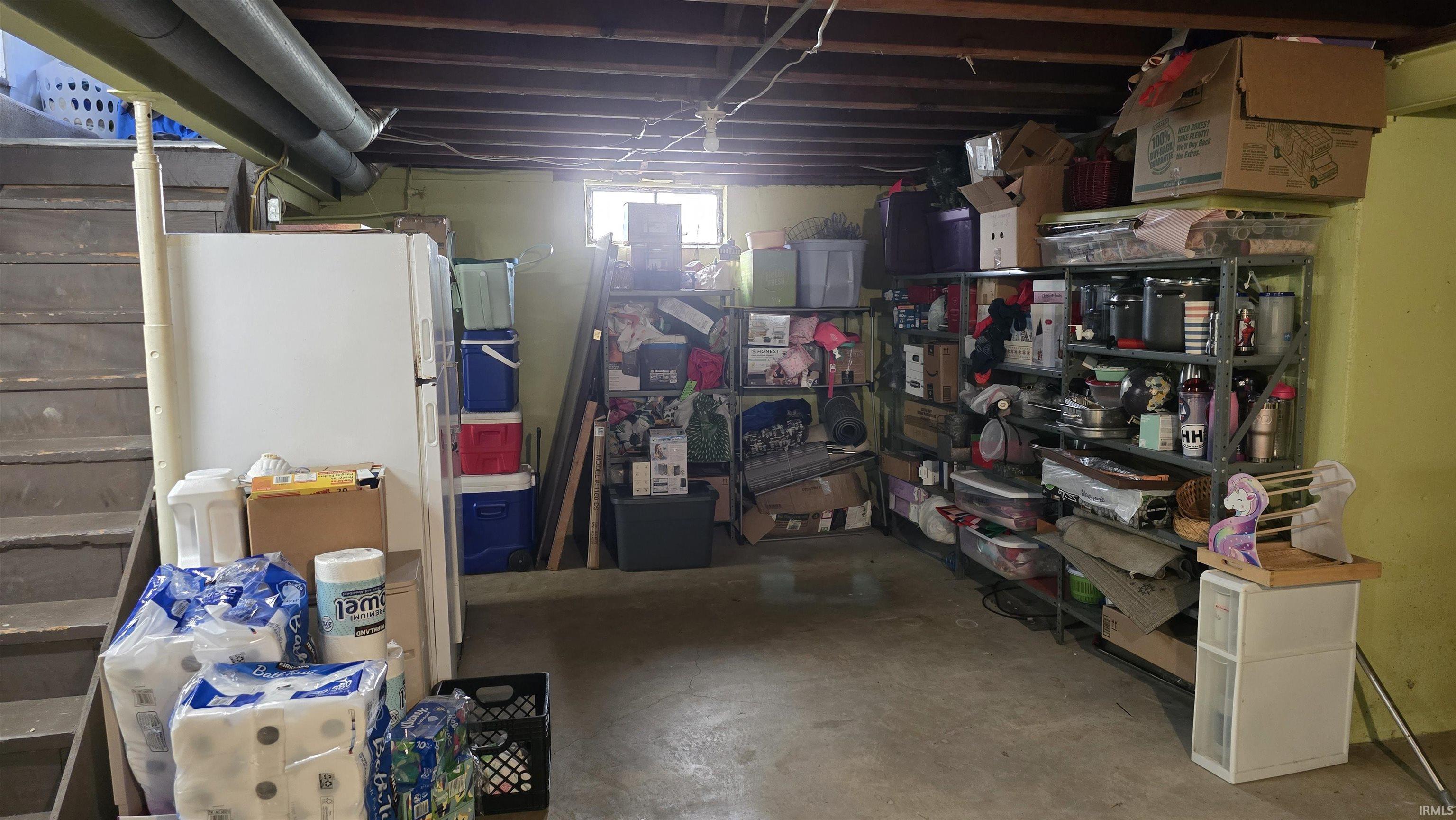 Below grade area with freestanding refrigerator