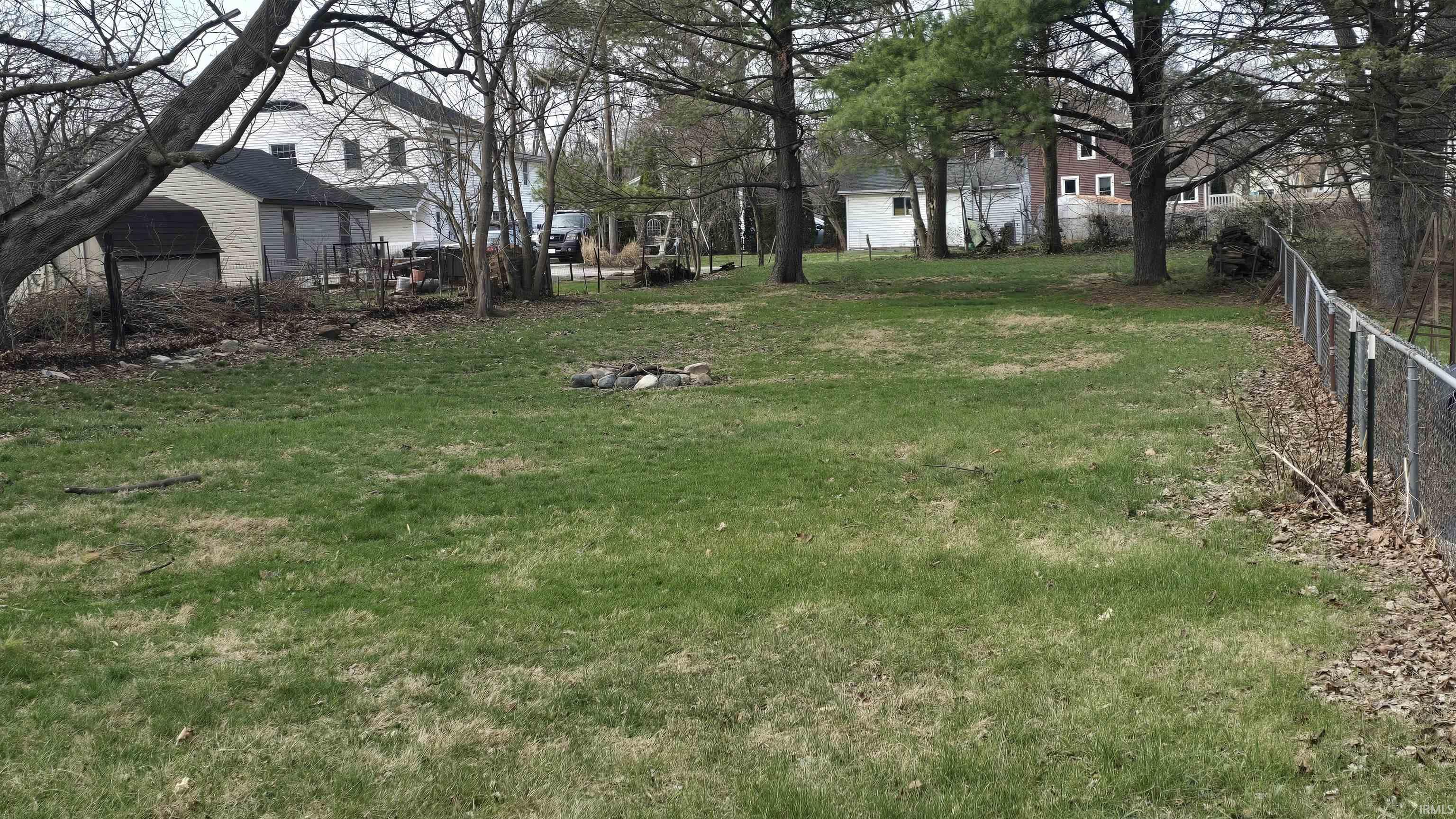 View of yard with an outdoor fire pit