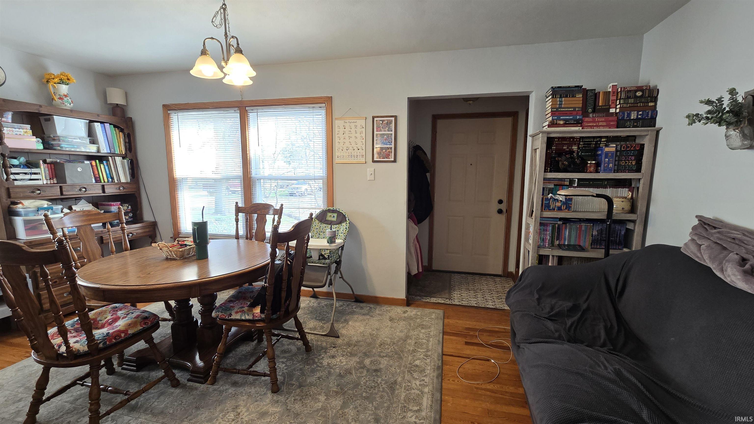 Dining space featuring wood finished floors and suspended lighting