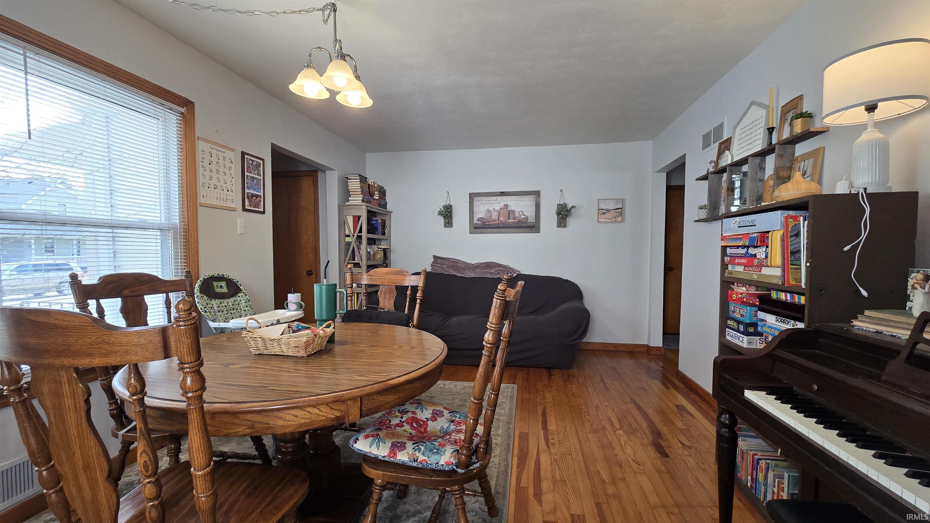Dining room featuring hardwood / wood-style floors and baseboards
