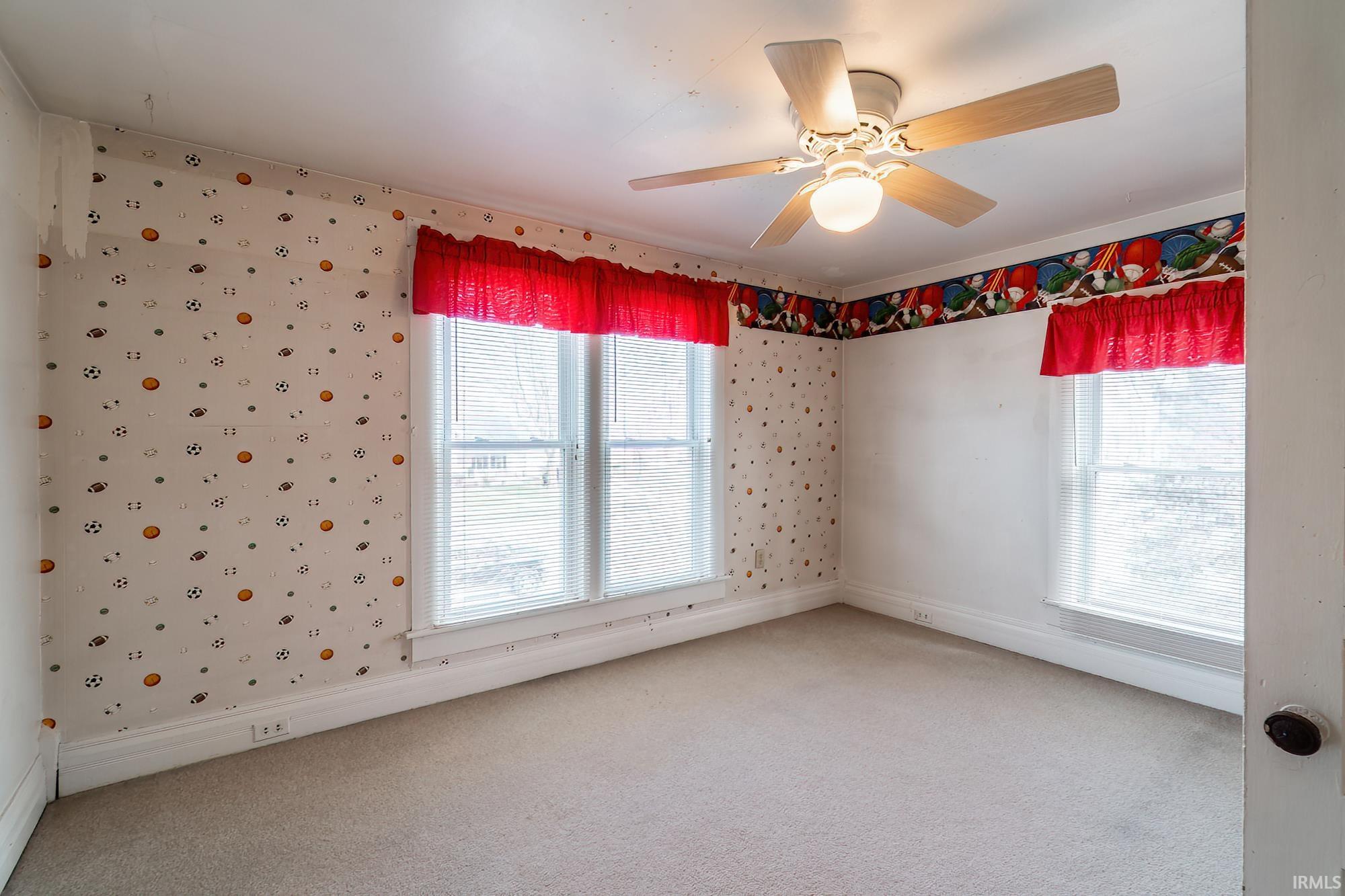 Bedroom 3 with wallpapered walls, ceiling fan, and light colored carpet