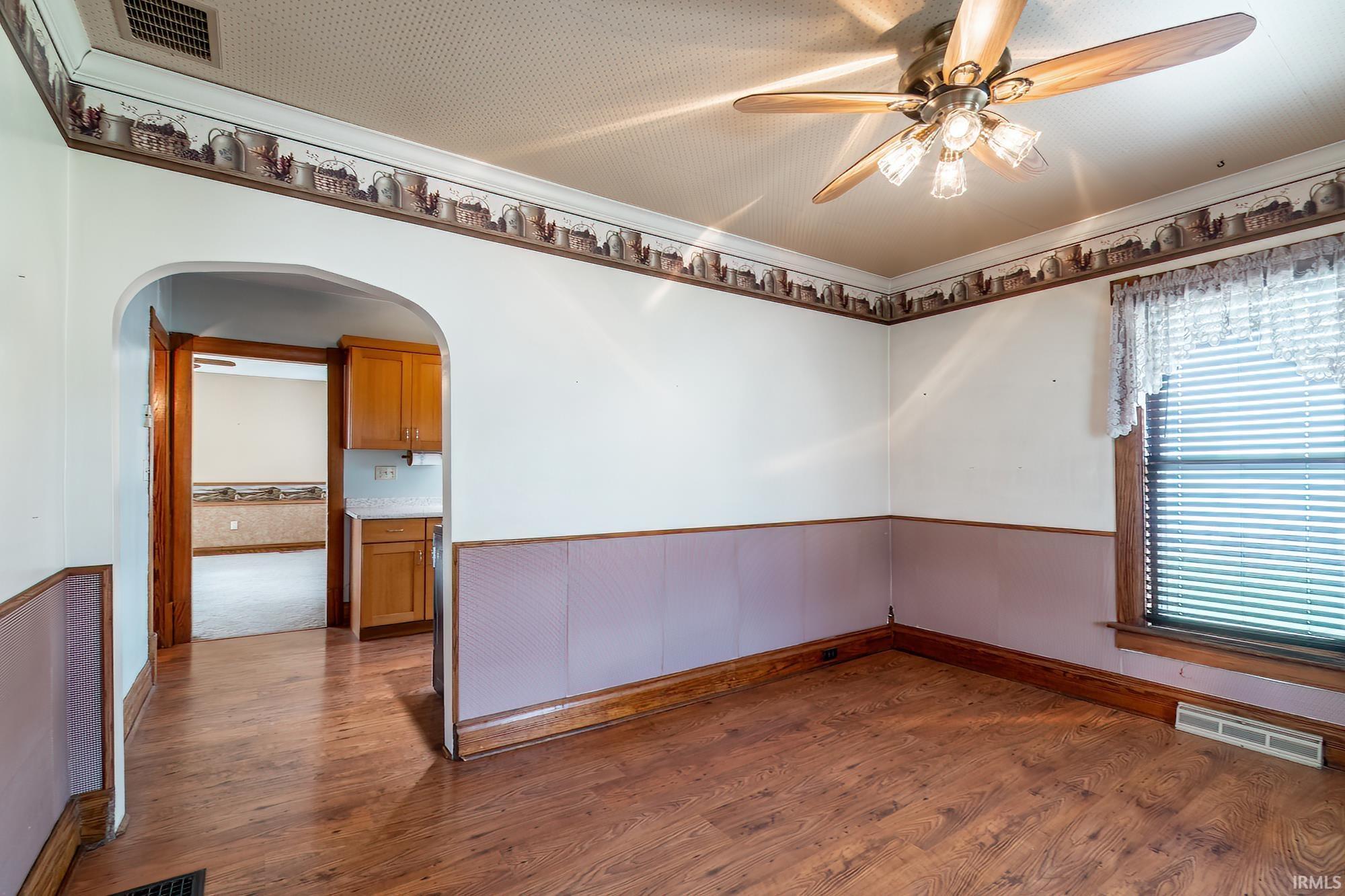 Rounded door entrance from dining room to the kitchen.