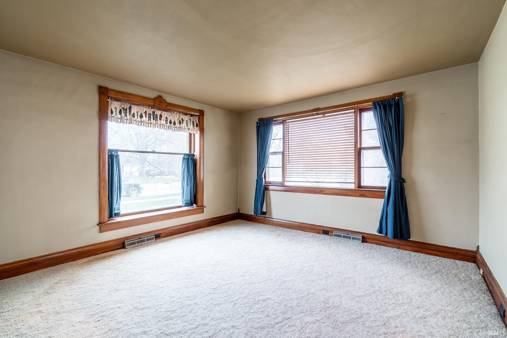 Carpeted living room with plenty of natural light