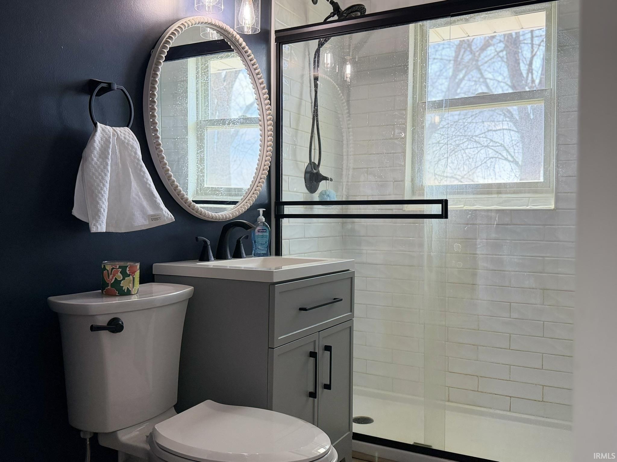 Bathroom featuring a stall shower and vanity