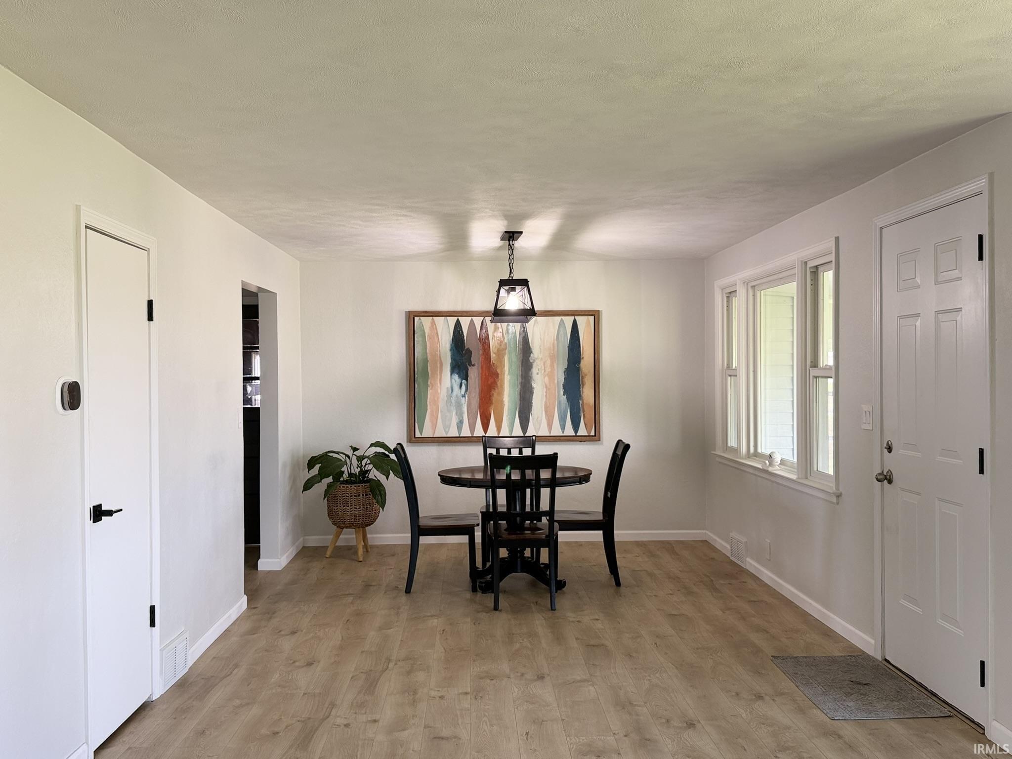 Dining area featuring light wood-type flooring and baseboards