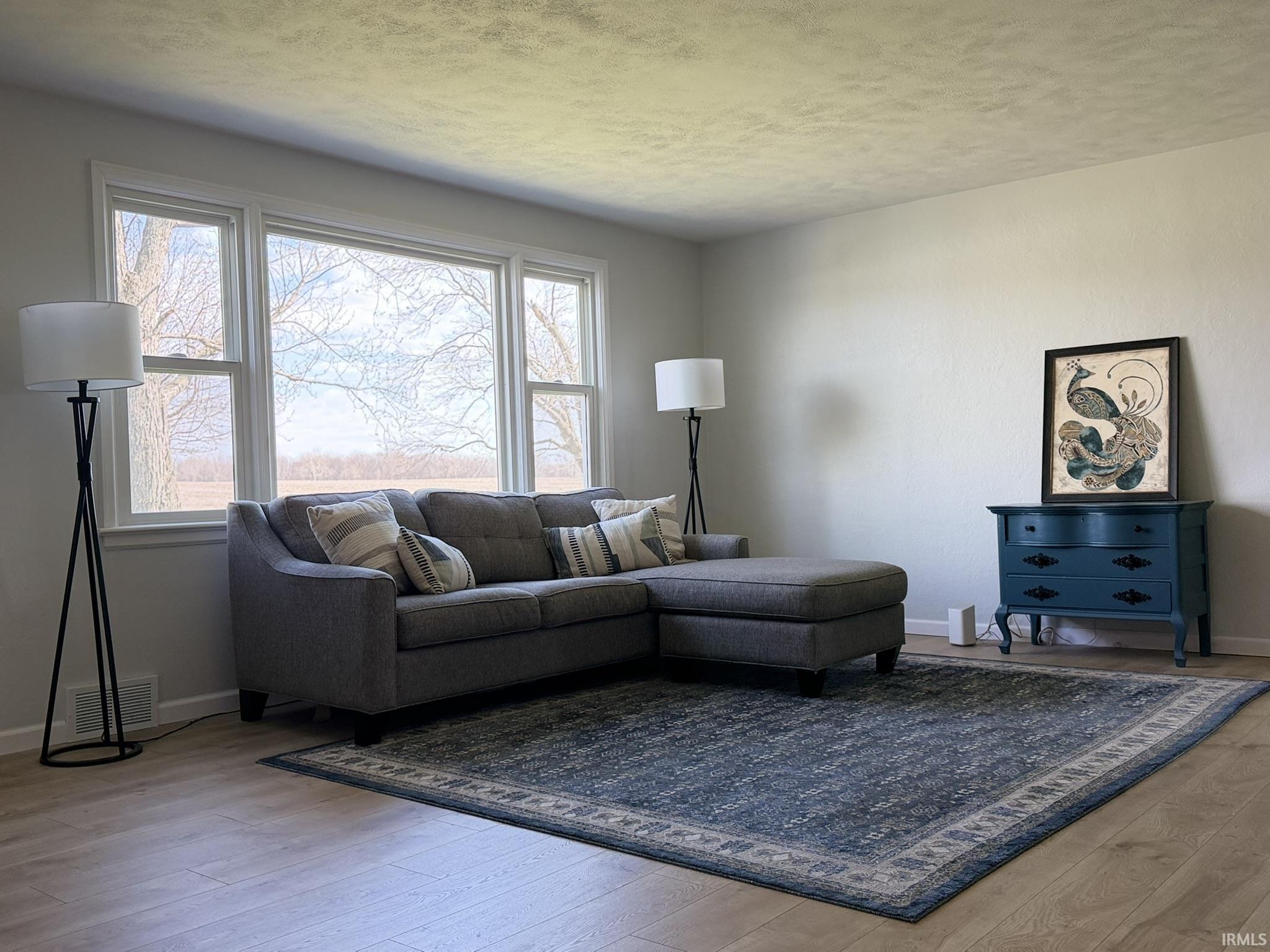Living area featuring baseboards and light wood-type flooring