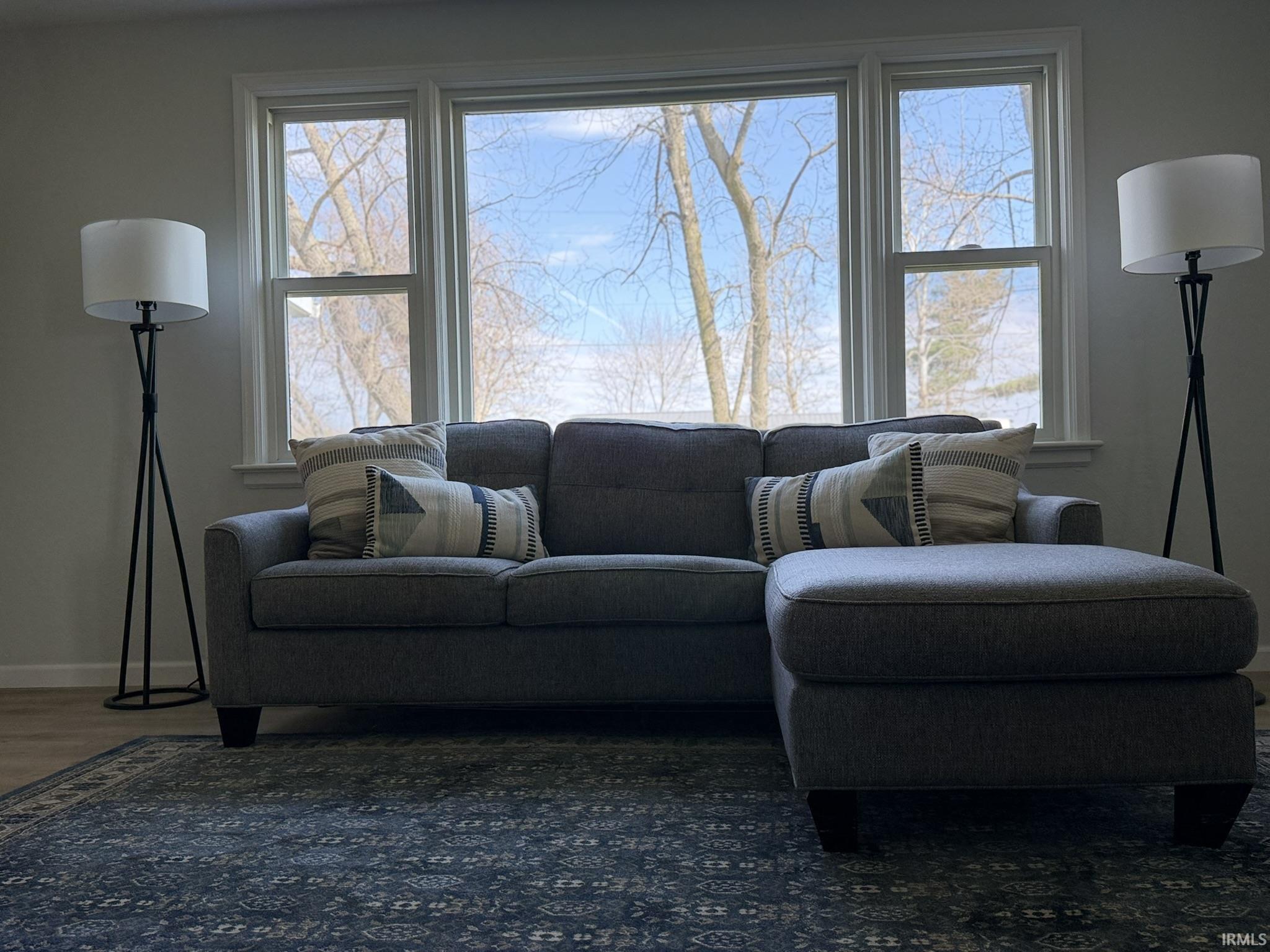 Living area featuring baseboards and wood finished floors