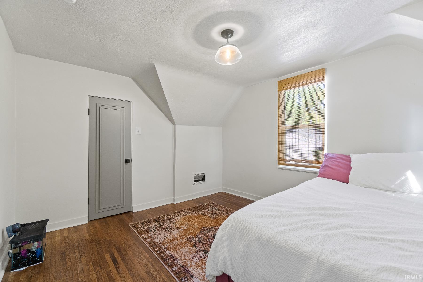 Bedroom with dark wood finished floors