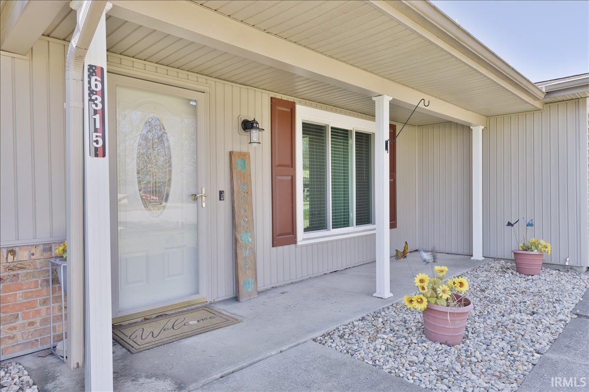 Doorway to property featuring a porch