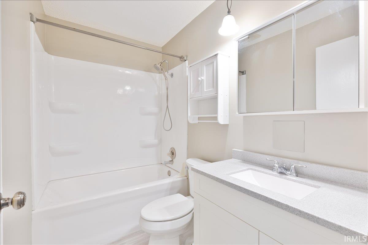 Full bathroom with vanity and bathtub / shower combination