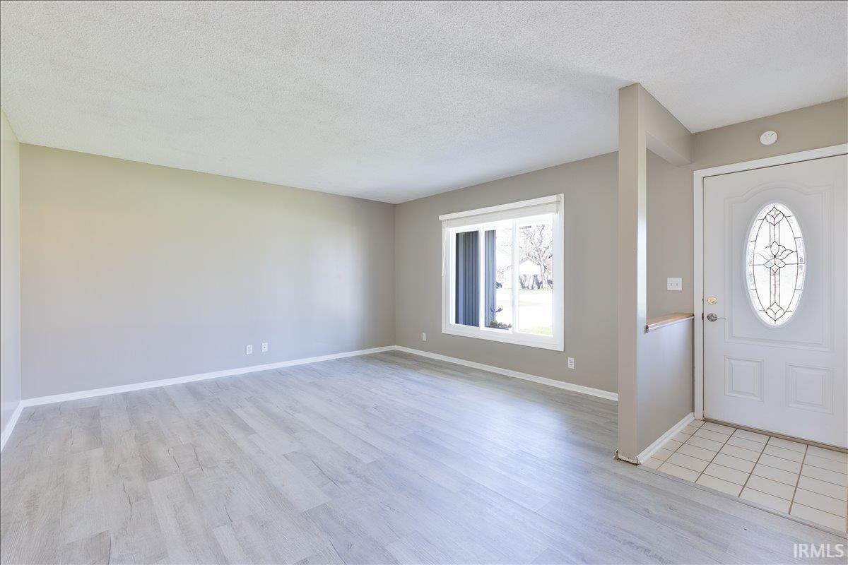 Entryway featuring a textured ceiling and light wood-style flooring