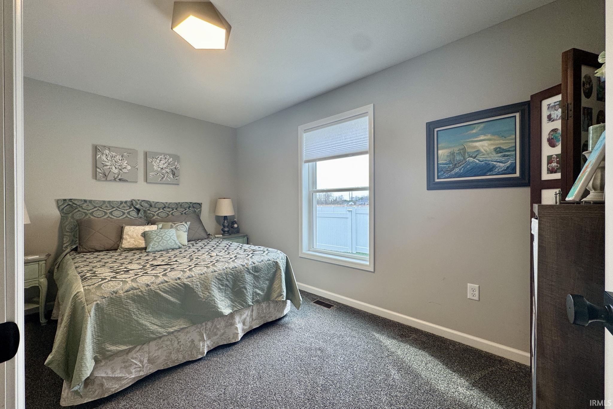 Carpeted bedroom featuring baseboards