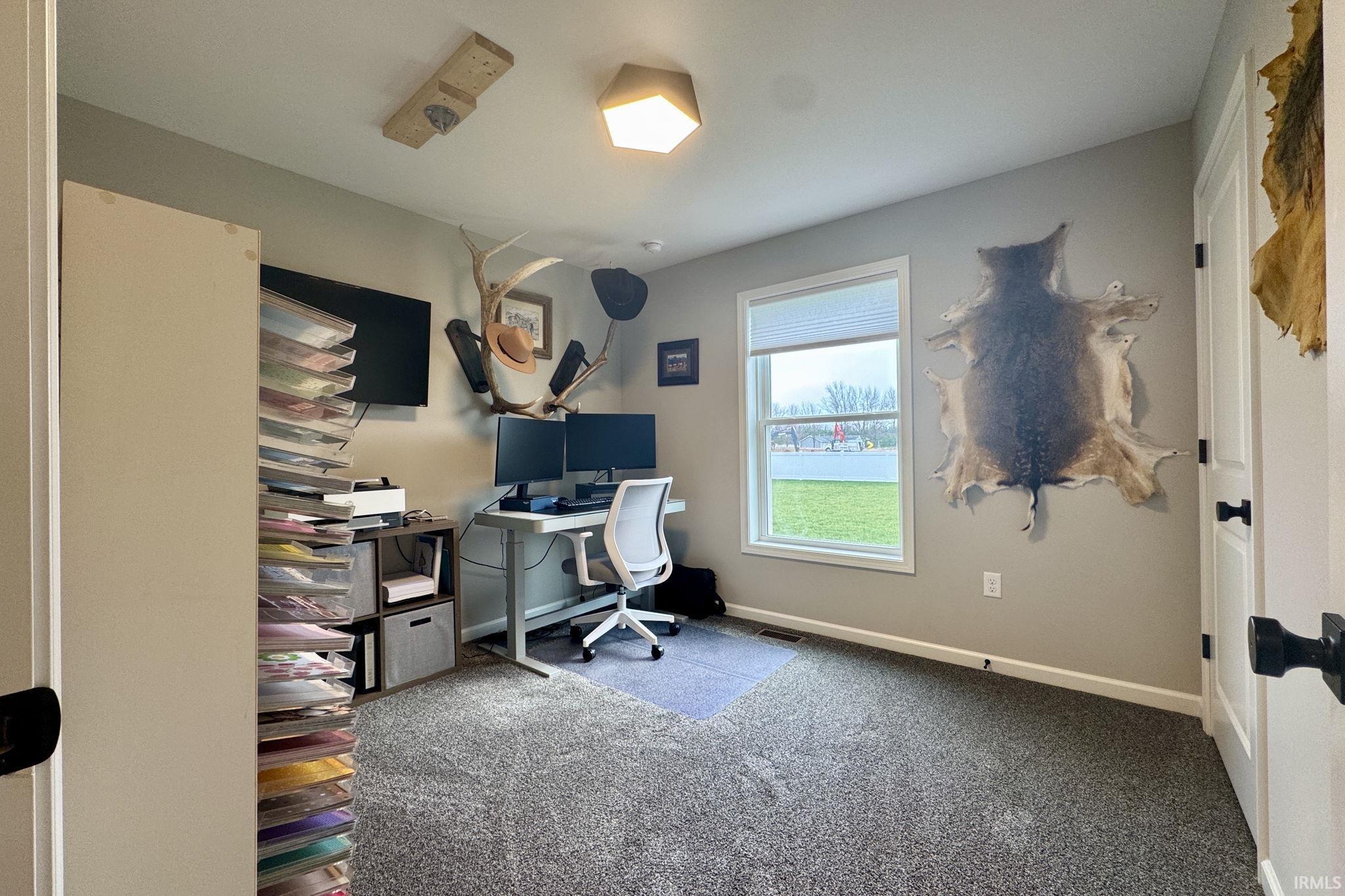 Carpeted office featuring baseboards