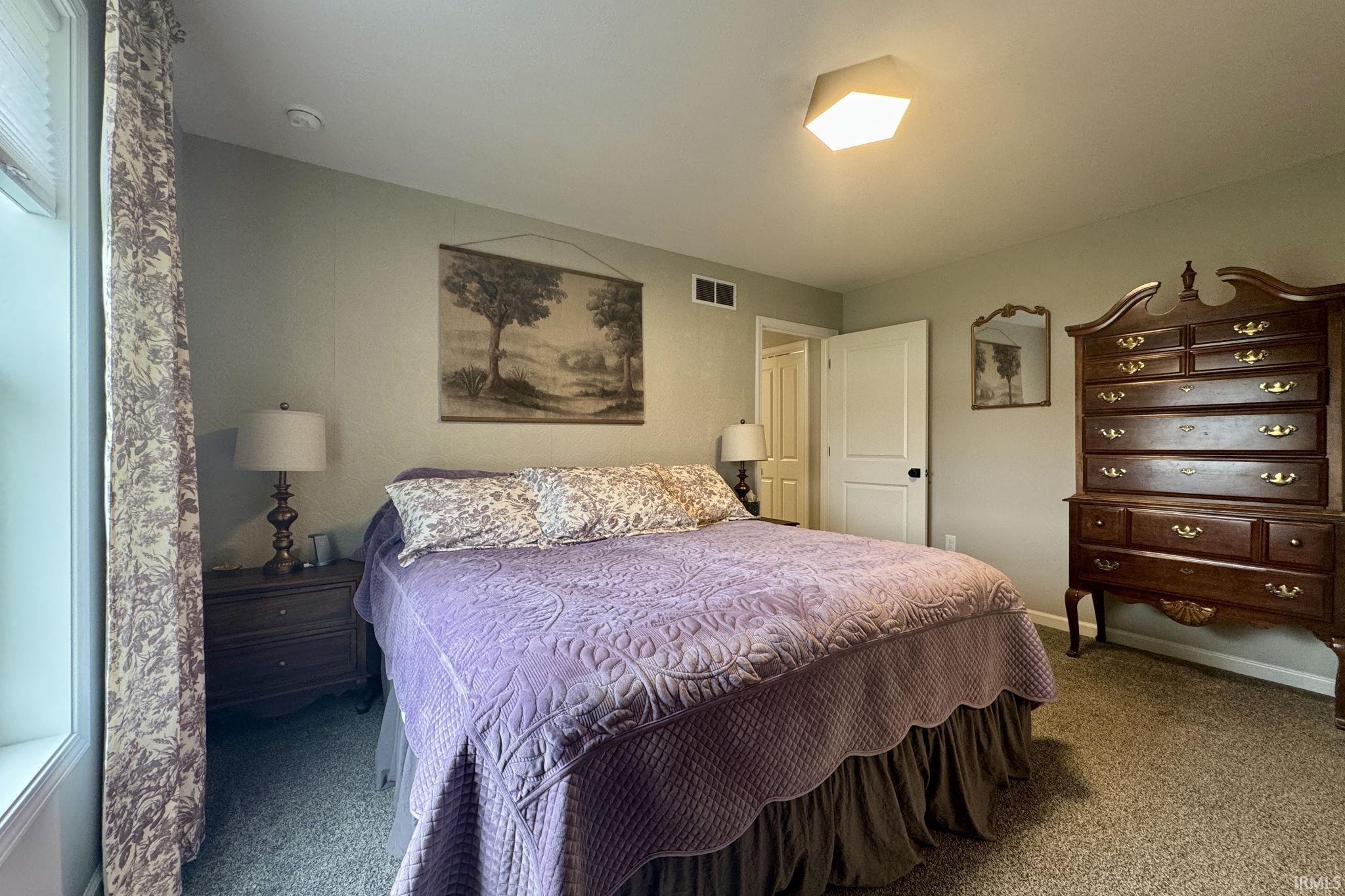 Carpeted bedroom with baseboards