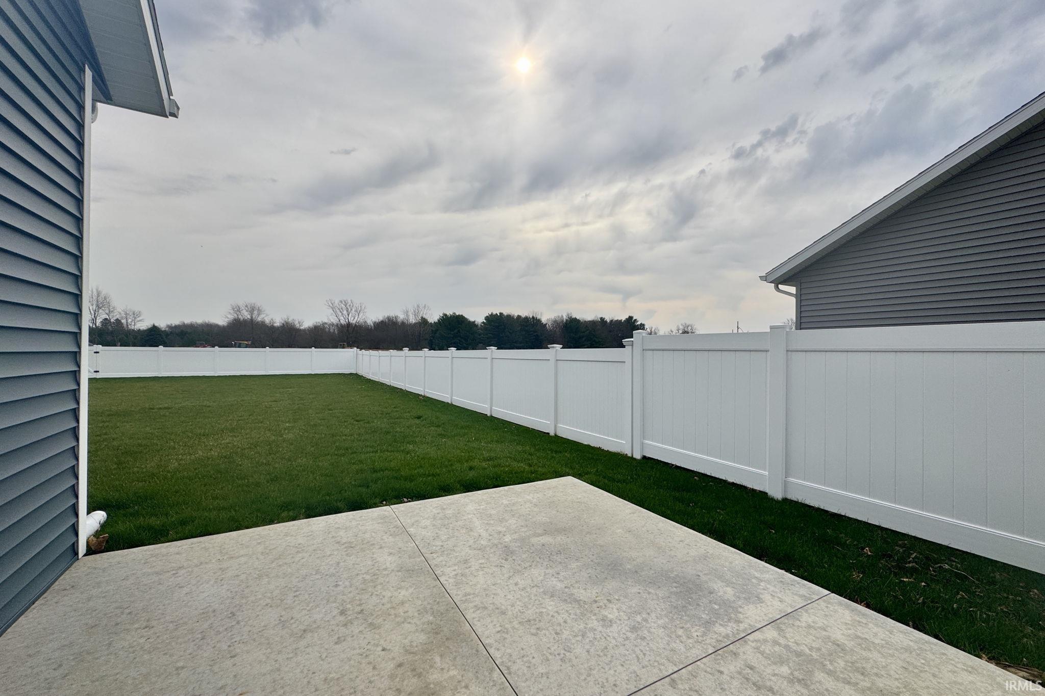 Fenced backyard with a patio