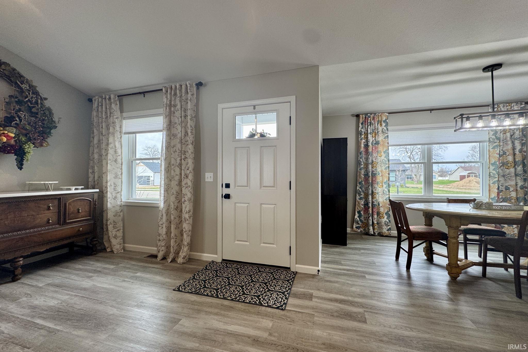 Entrance foyer featuring light wood finished floors and baseboards