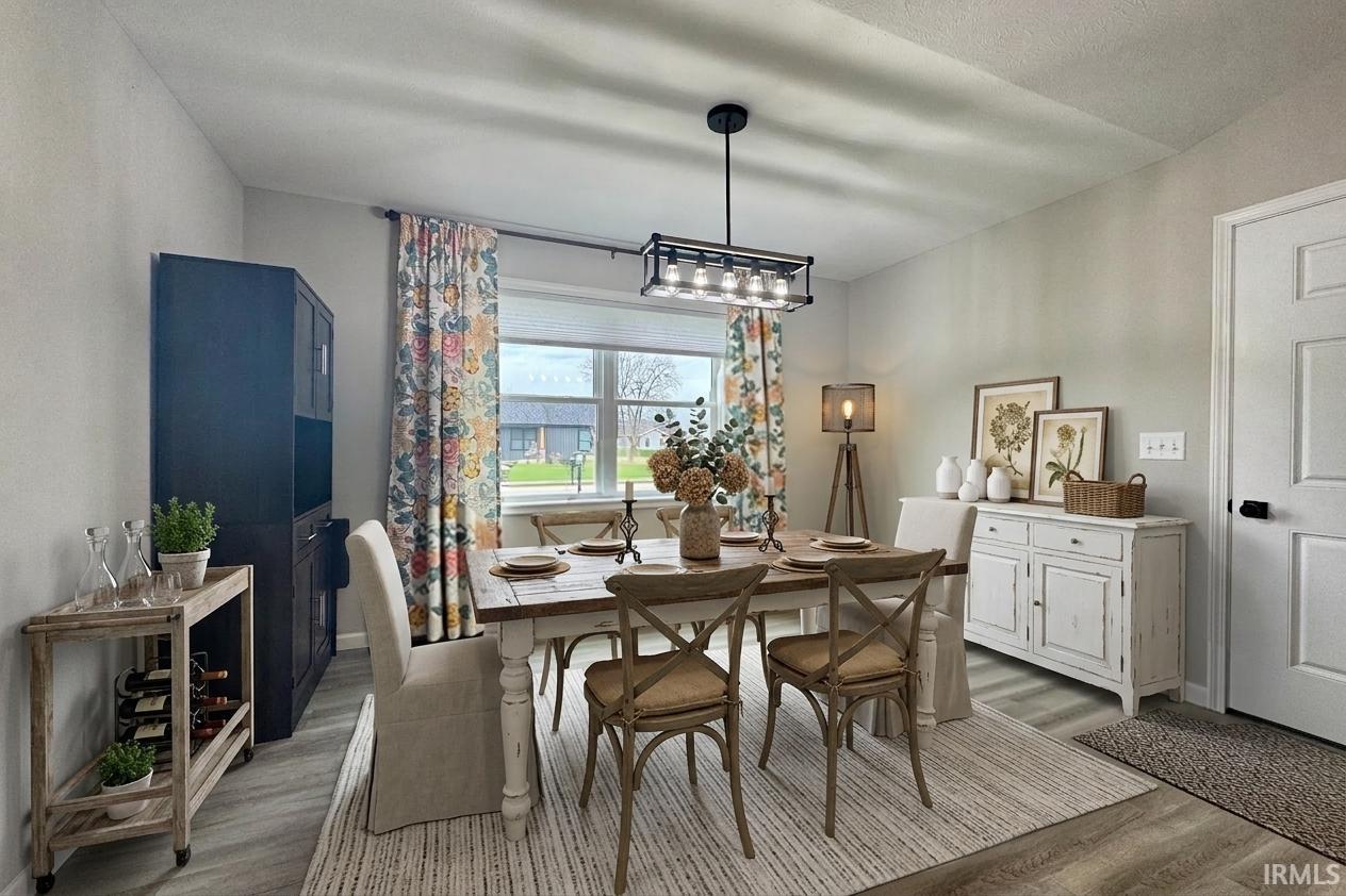 Wood-finish flooring, recessed lighting, and a contemporary chandelier