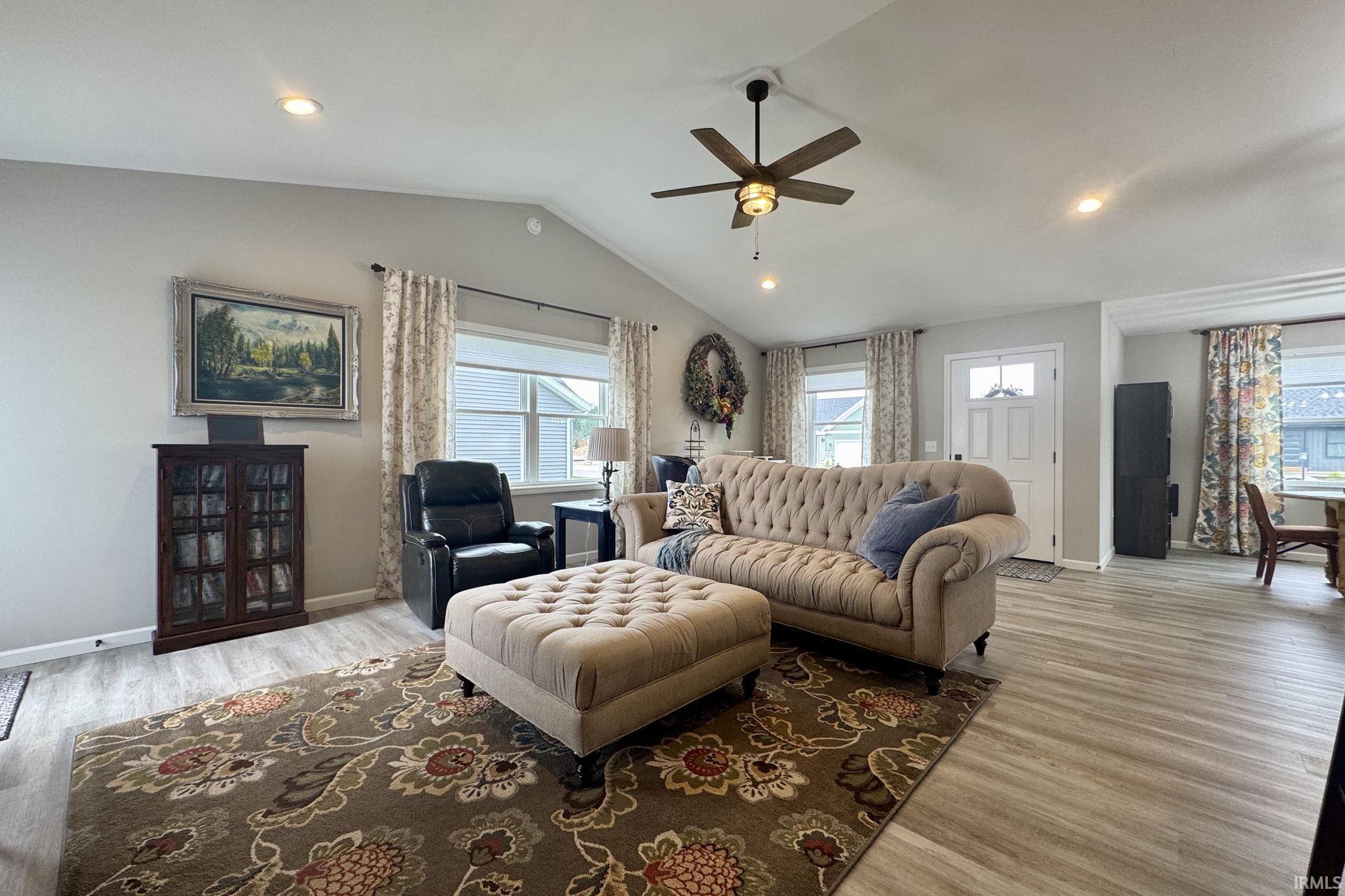 Living room featuring ceiling fan, light wood-style flooring, and recessed lighting