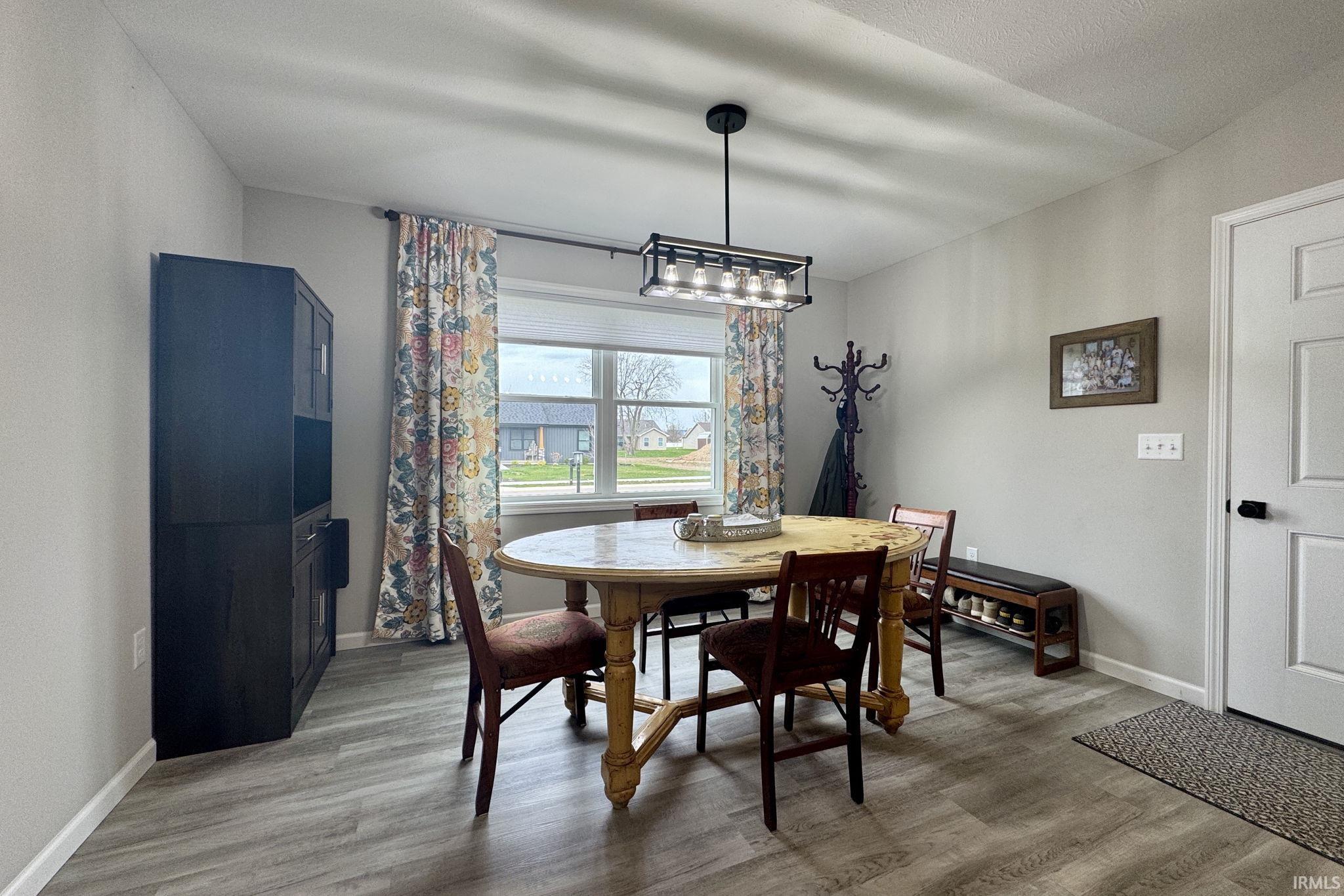Dining space featuring light wood-style floors and baseboards