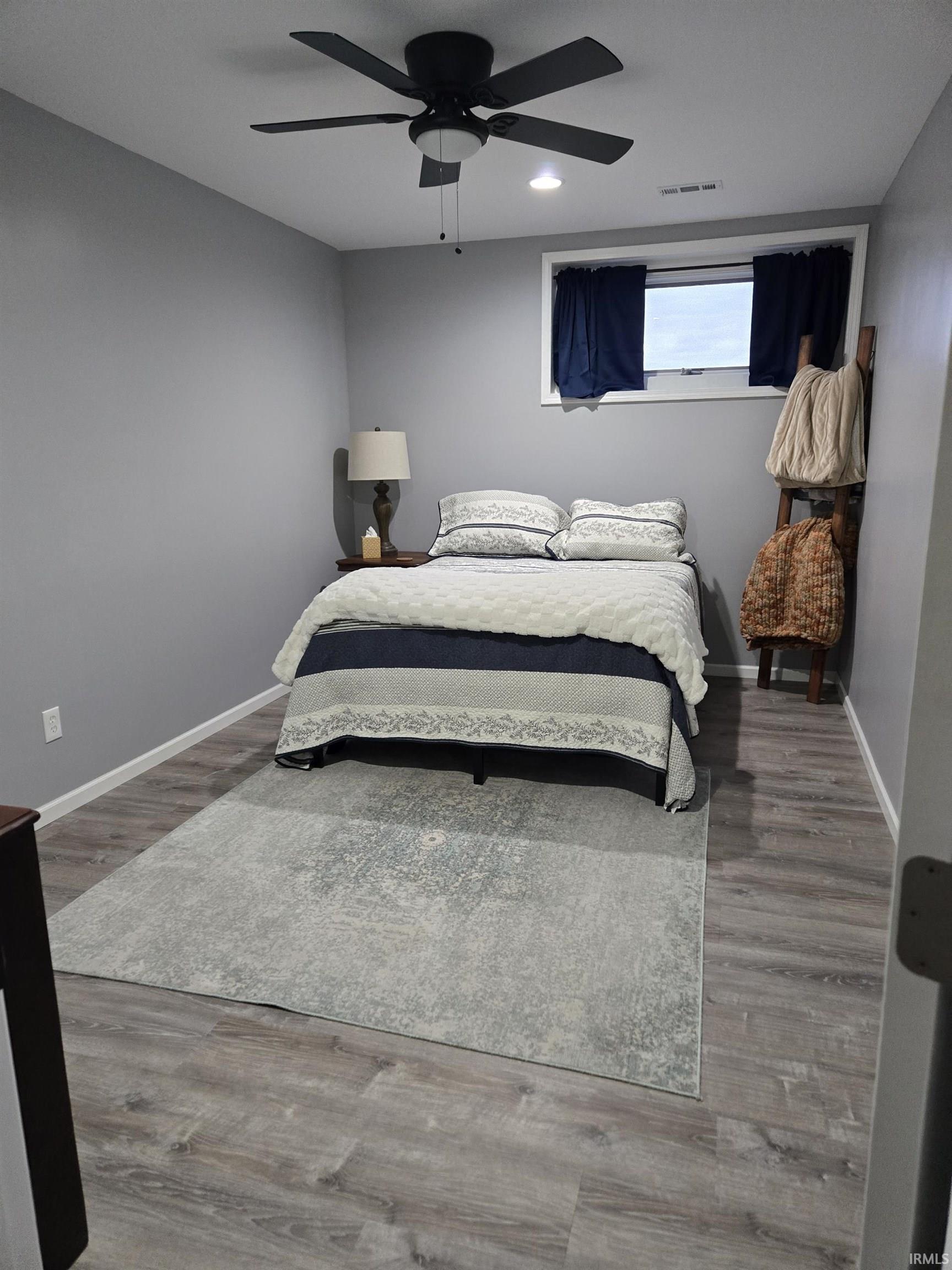 Bedroom featuring wood finished floors, a ceiling fan, and recessed lighting