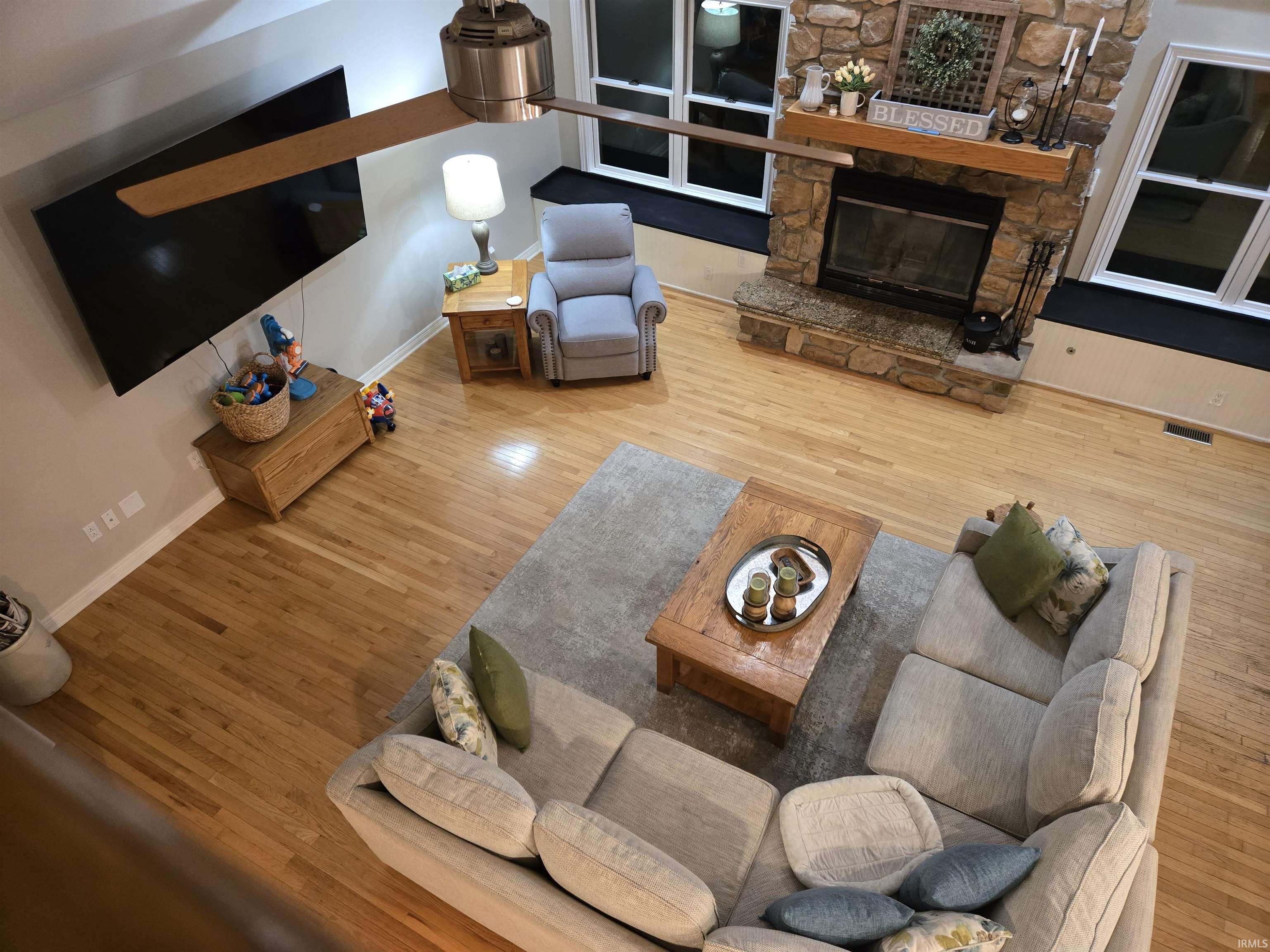 Living area with wood finished floors and a fireplace