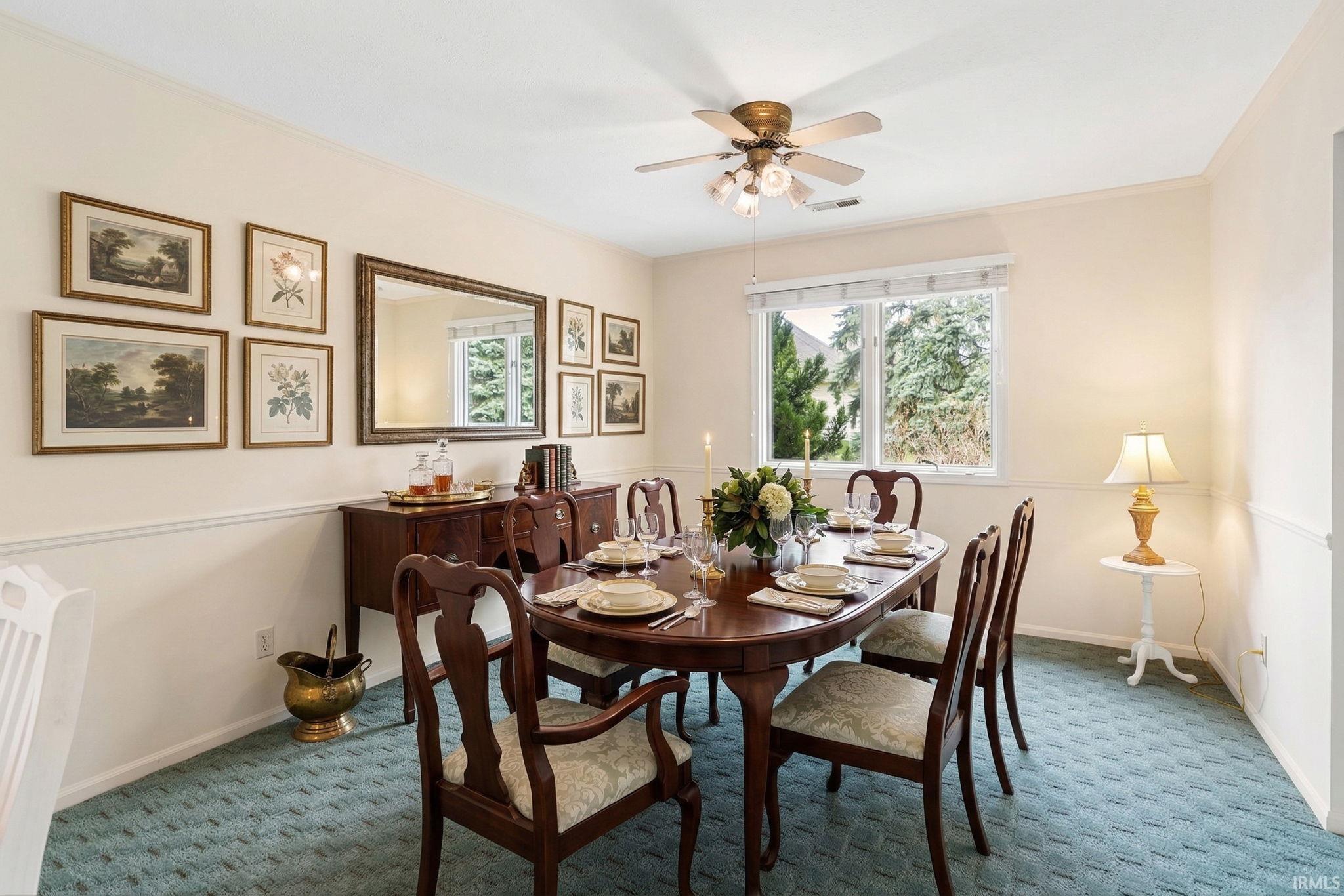 Dining space featuring carpet flooring, healthy amount of natural light, and ceiling fan