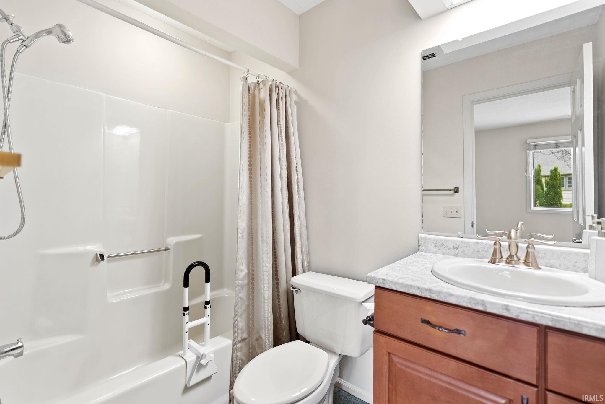 Bathroom with vanity and shower / bath combo