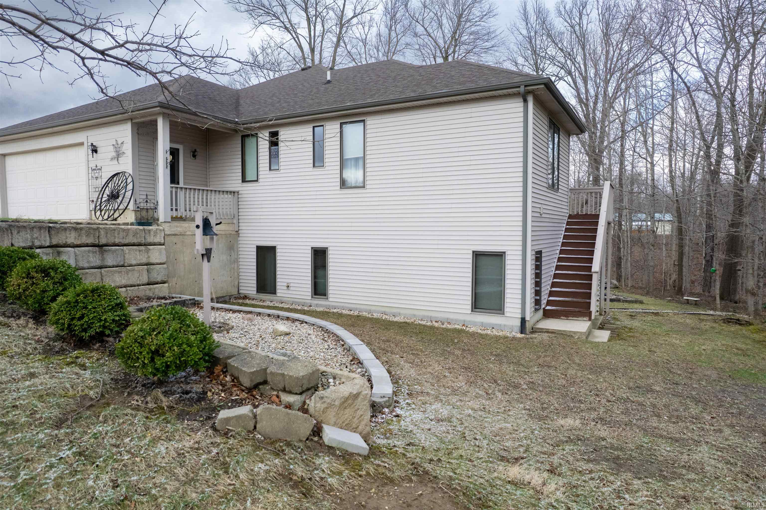 View of home's exterior featuring a garage and roof with shingles