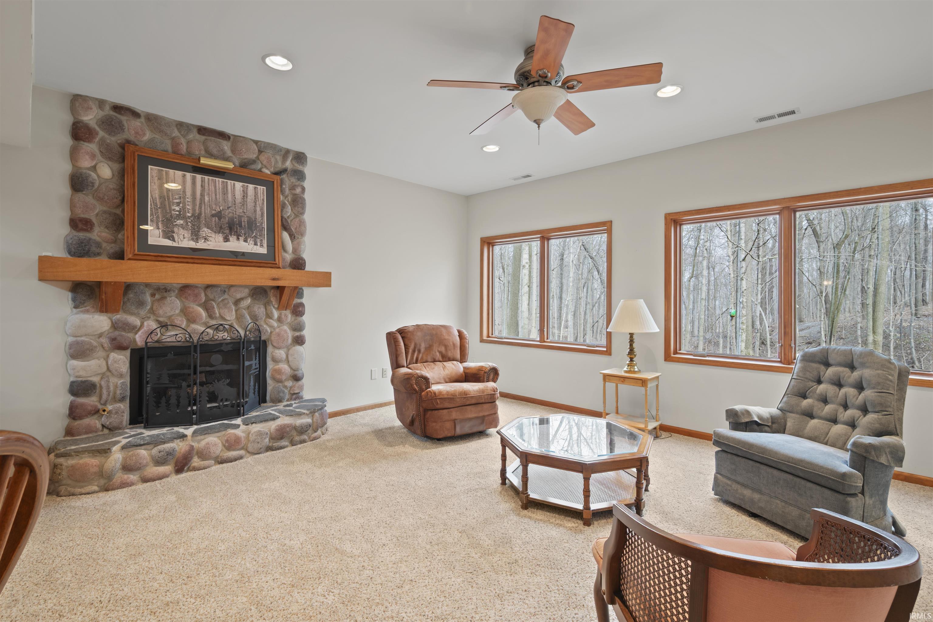 Living room featuring ceiling fan, a fireplace, carpet flooring, and recessed lighting