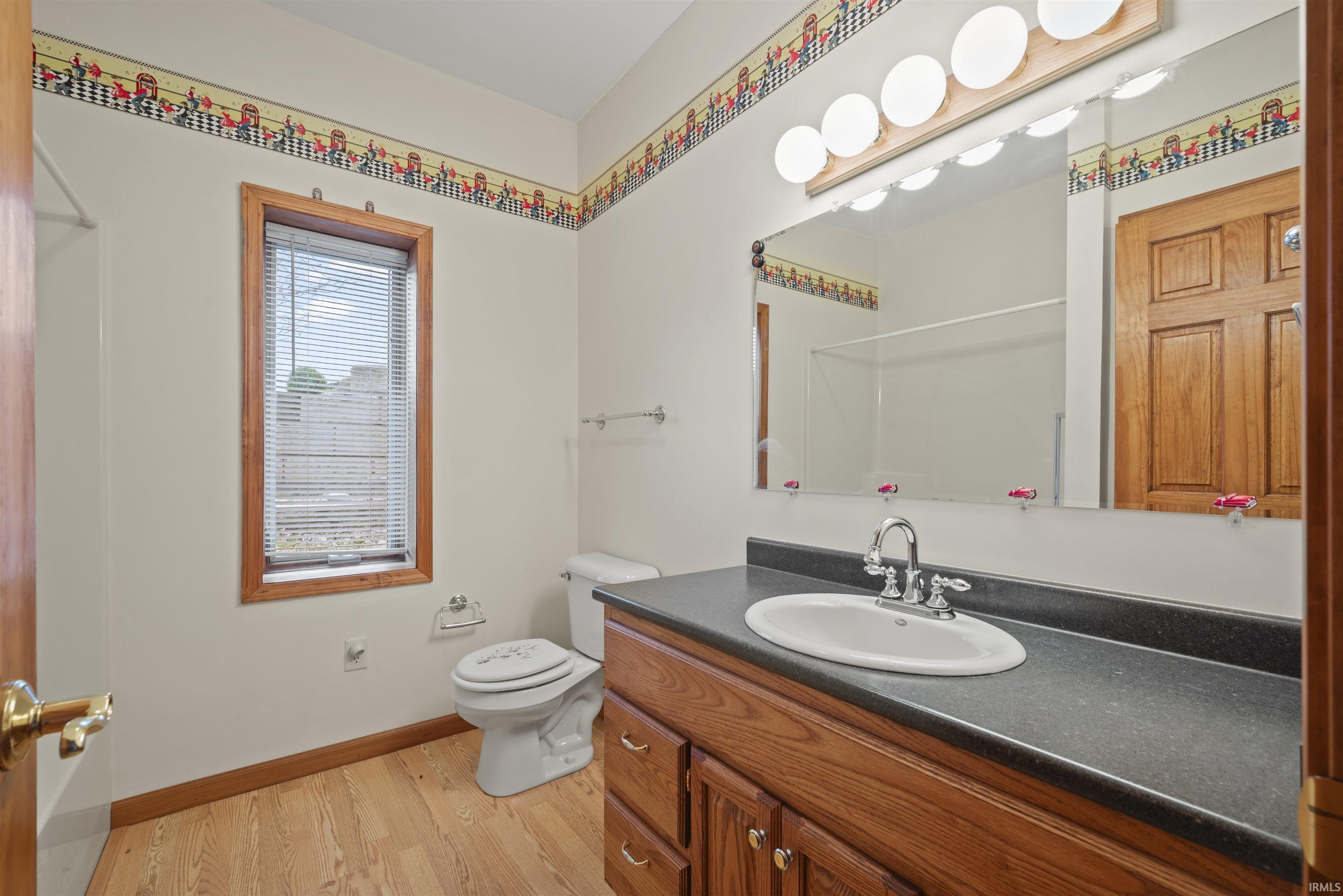 Bathroom with vanity and light wood-type flooring