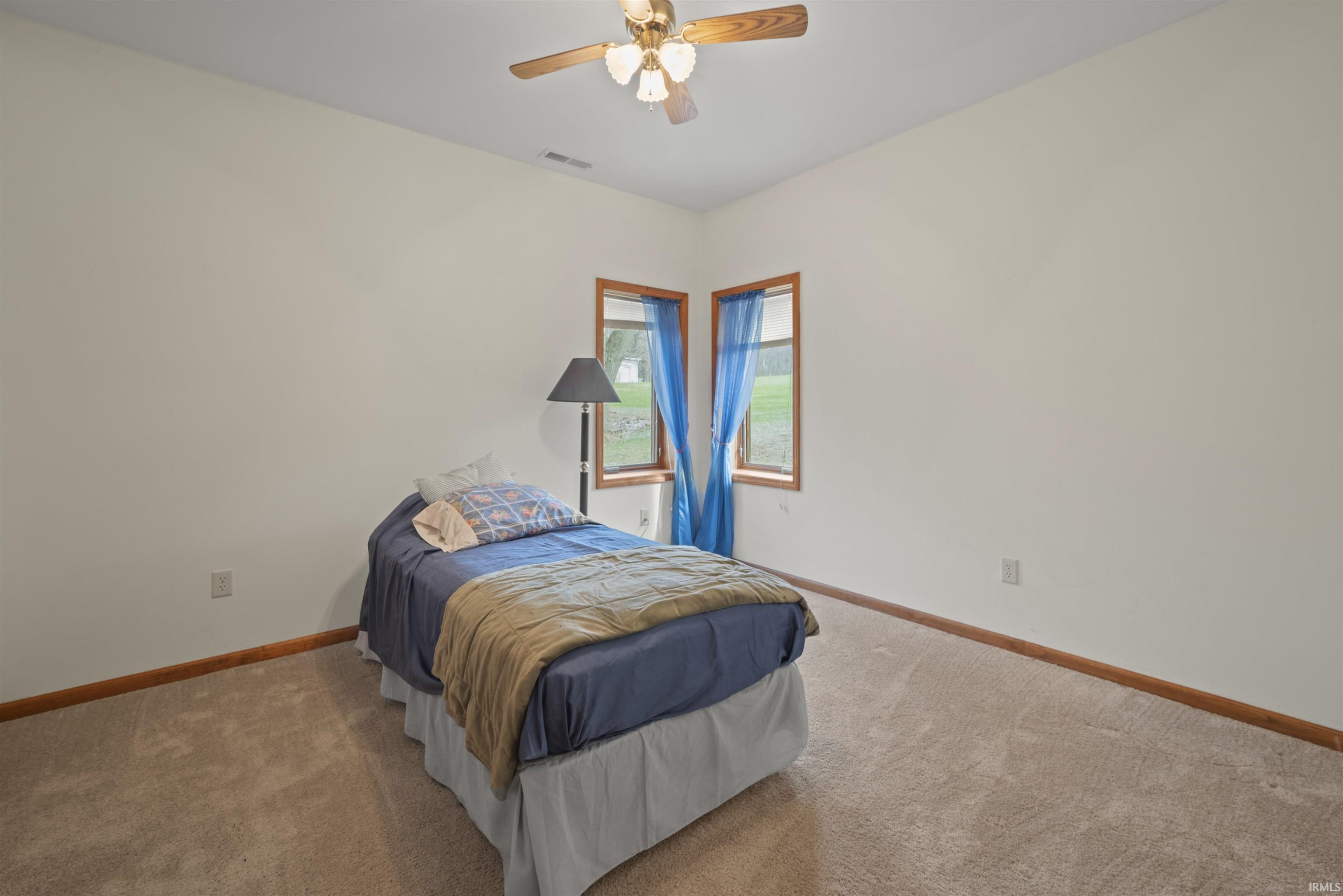 Bedroom with carpet and ceiling fan