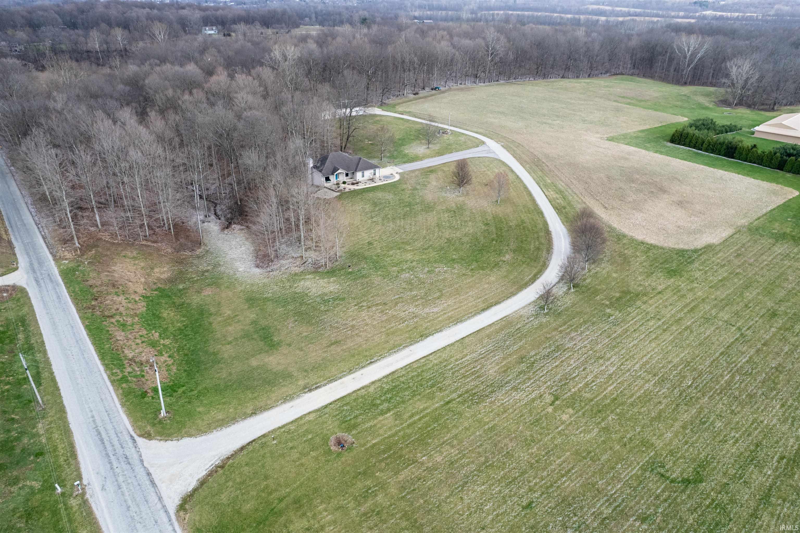 Aerial view of sparsely populated area featuring a heavily wooded area