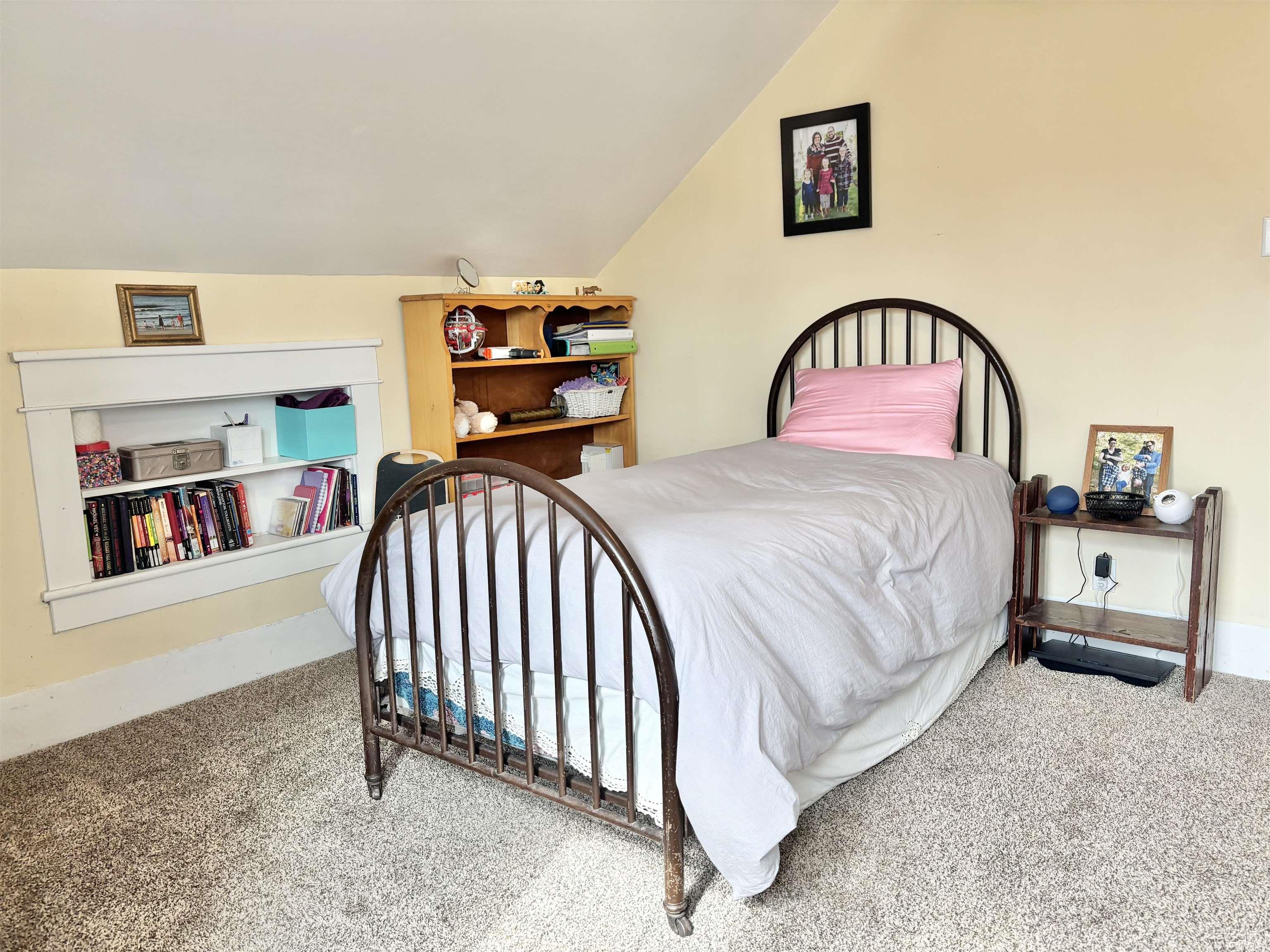 Carpeted bedroom with lofted ceiling