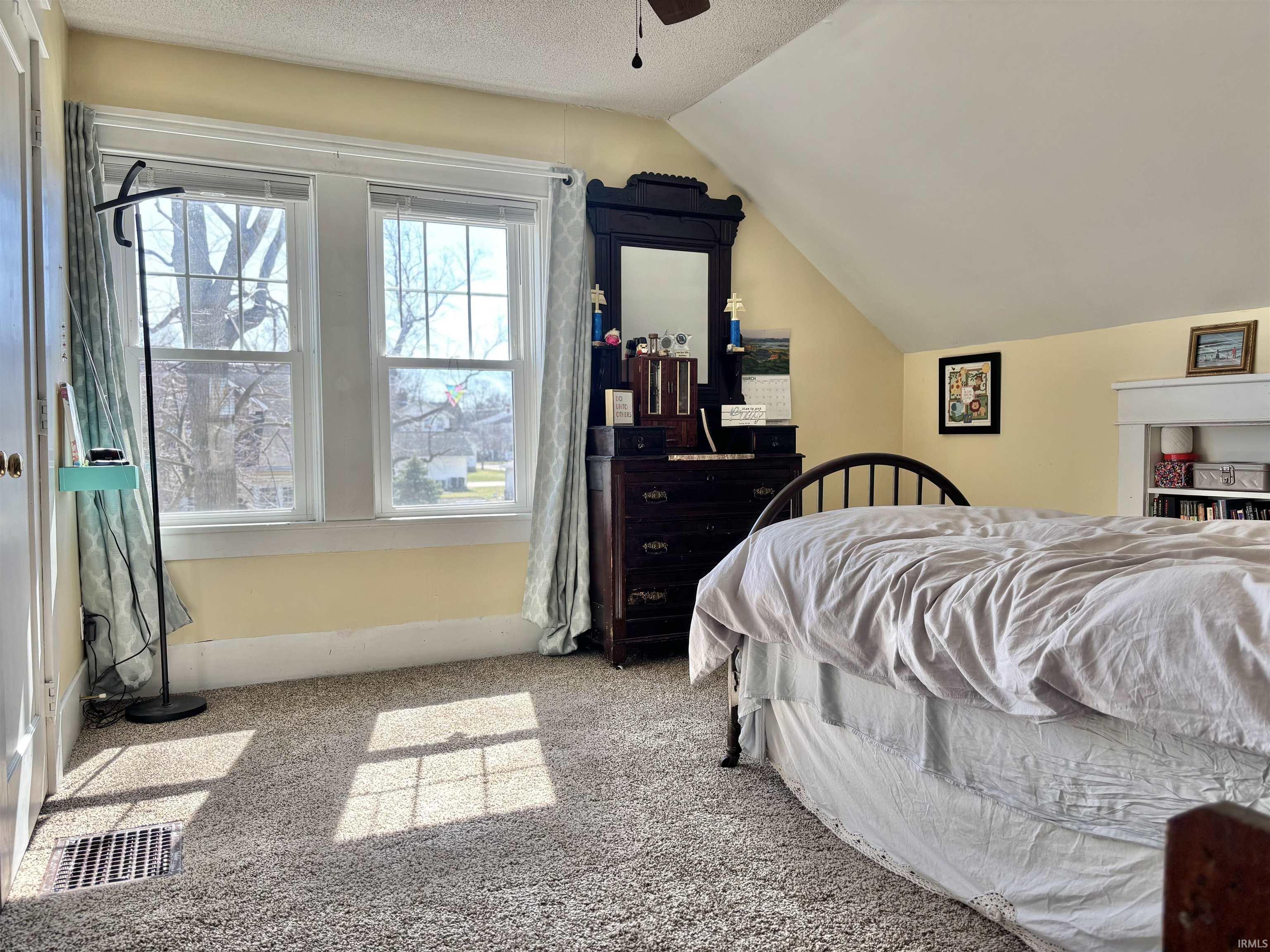 Bedroom featuring light carpet