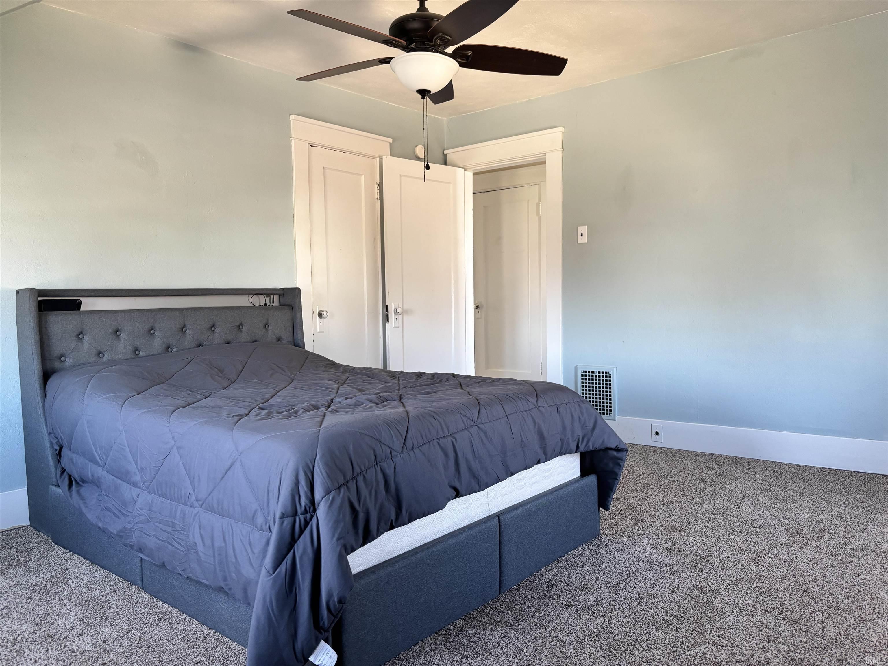 Bedroom with carpet flooring and a ceiling fan