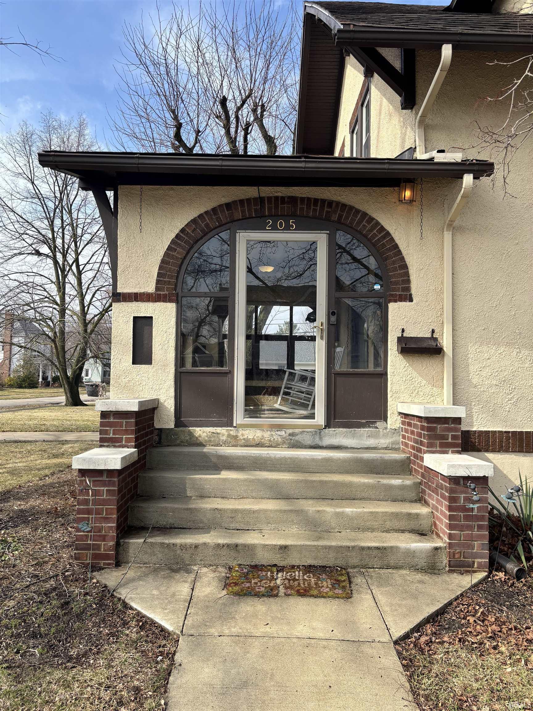 Entrance to property with stucco siding