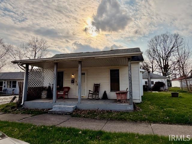Bungalow-style house with covered porch and a front yard